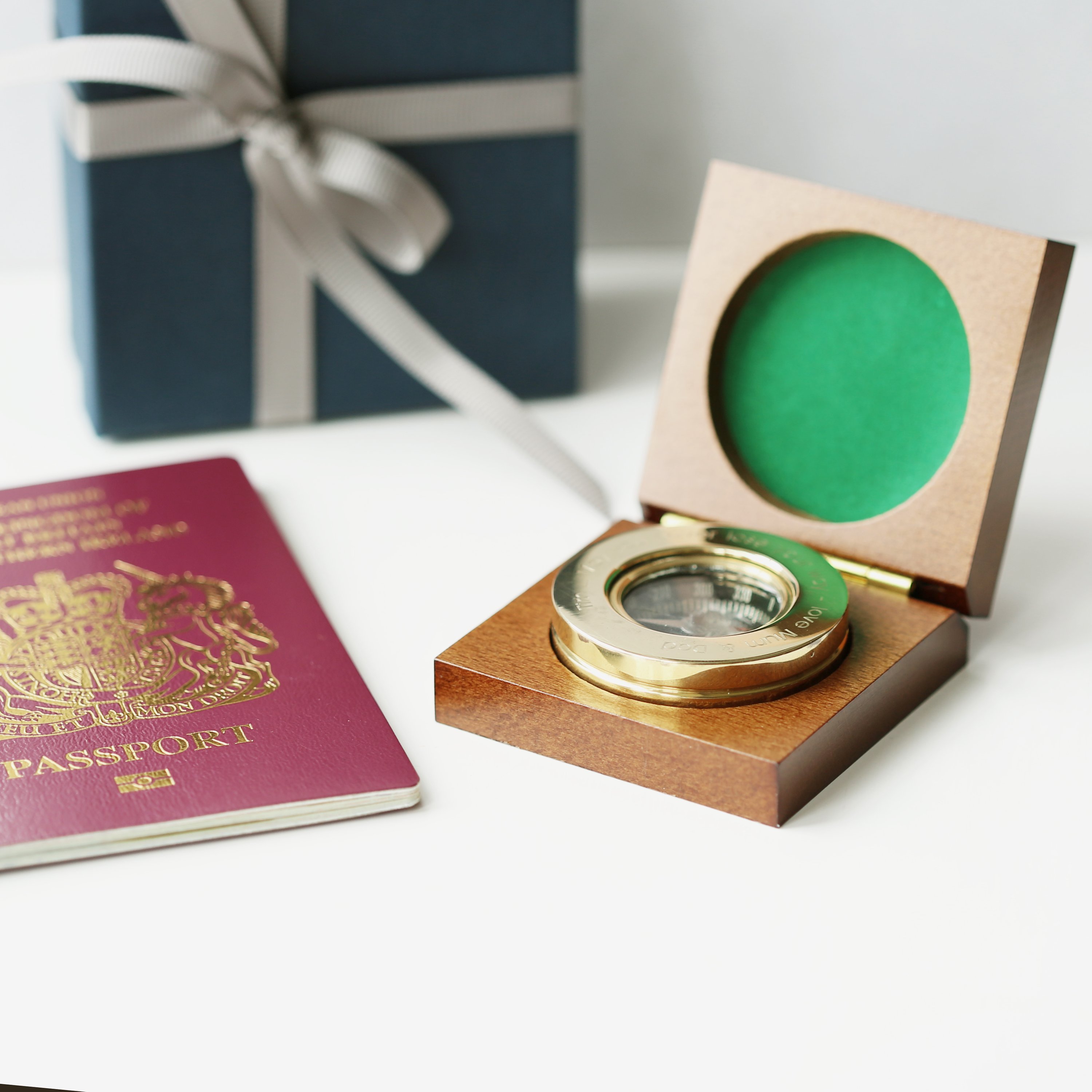 Personalised brass compass displayed in a fine mahogany timber box, showcasing its elegant design and engraving.