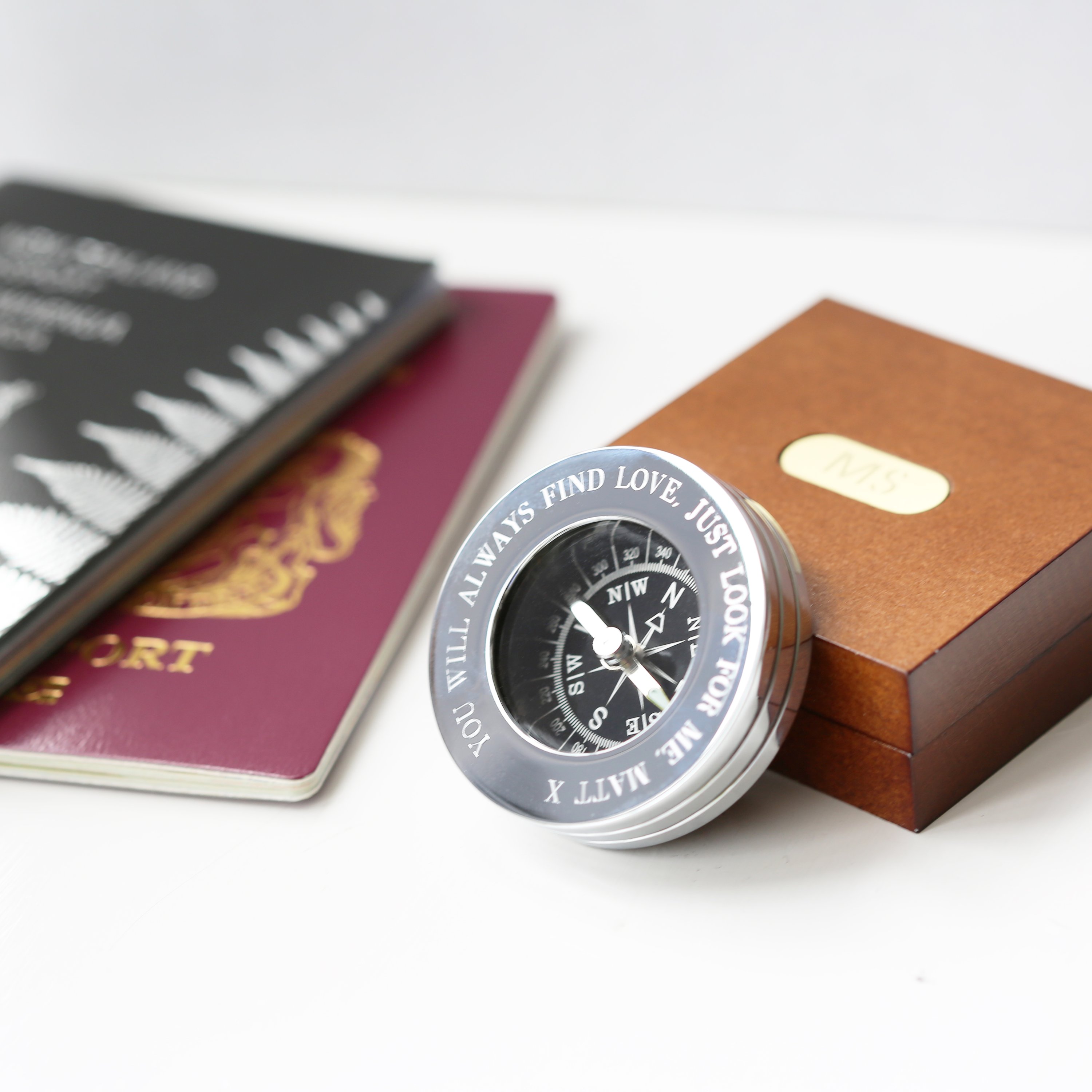 Personalised brass compass displayed in a fine mahogany timber box, showcasing its elegant design and engraving.