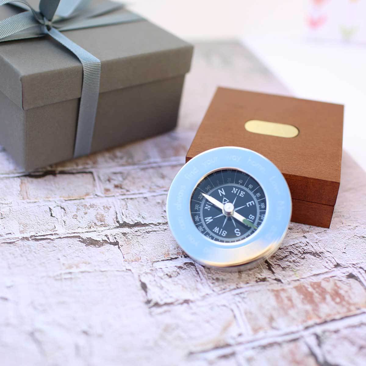 Personalised brass compass displayed in a fine mahogany timber box, showcasing its elegant design and engraving.