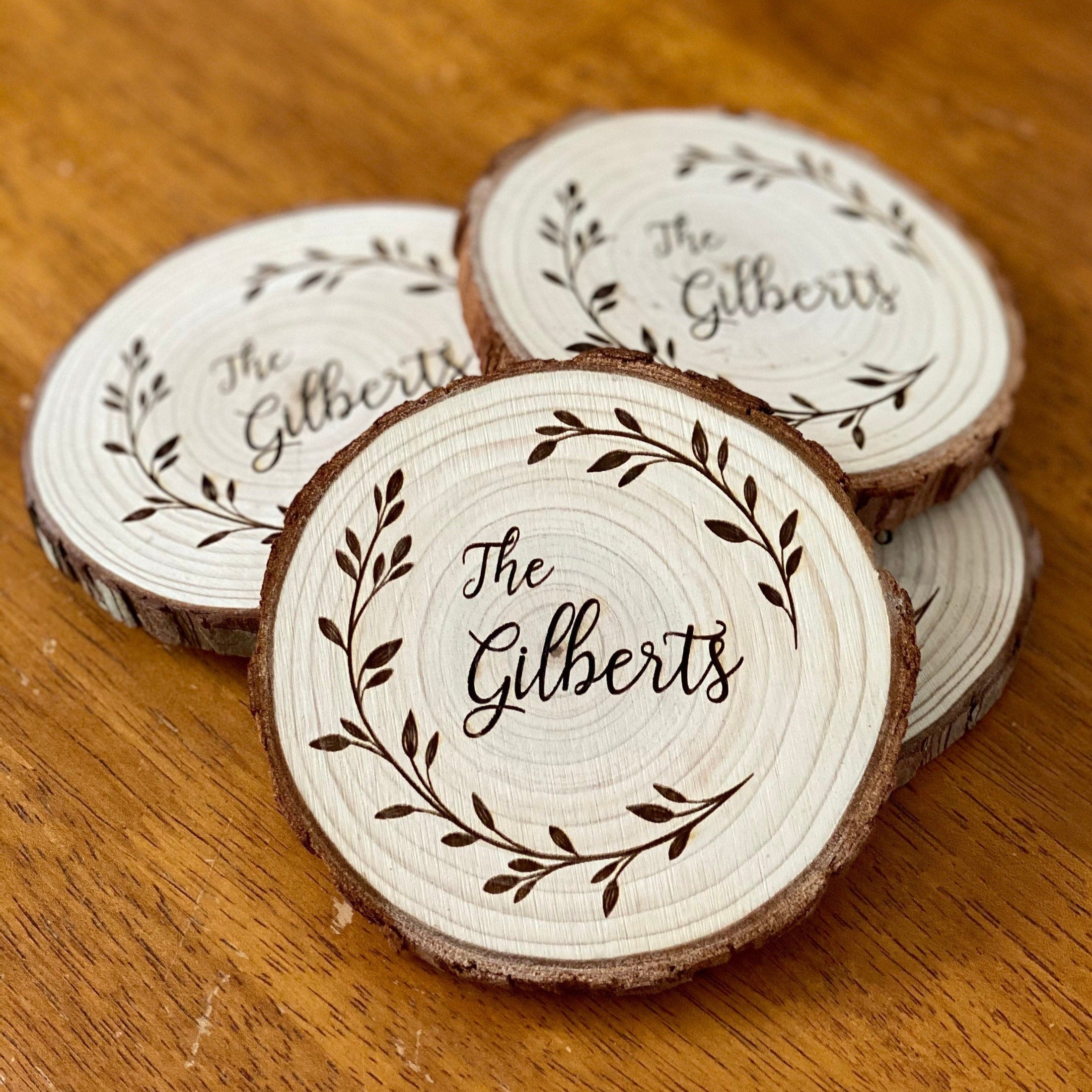 Custom family name engraved wood coasters set made from Californian Pine, showcasing rustic design and laser engraving.