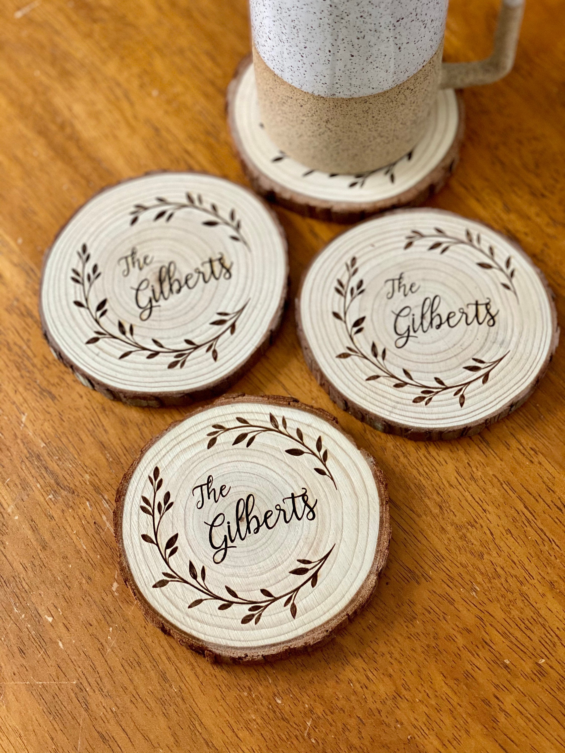 Custom family name engraved wood coasters set made from Californian Pine, showcasing rustic design and laser engraving.