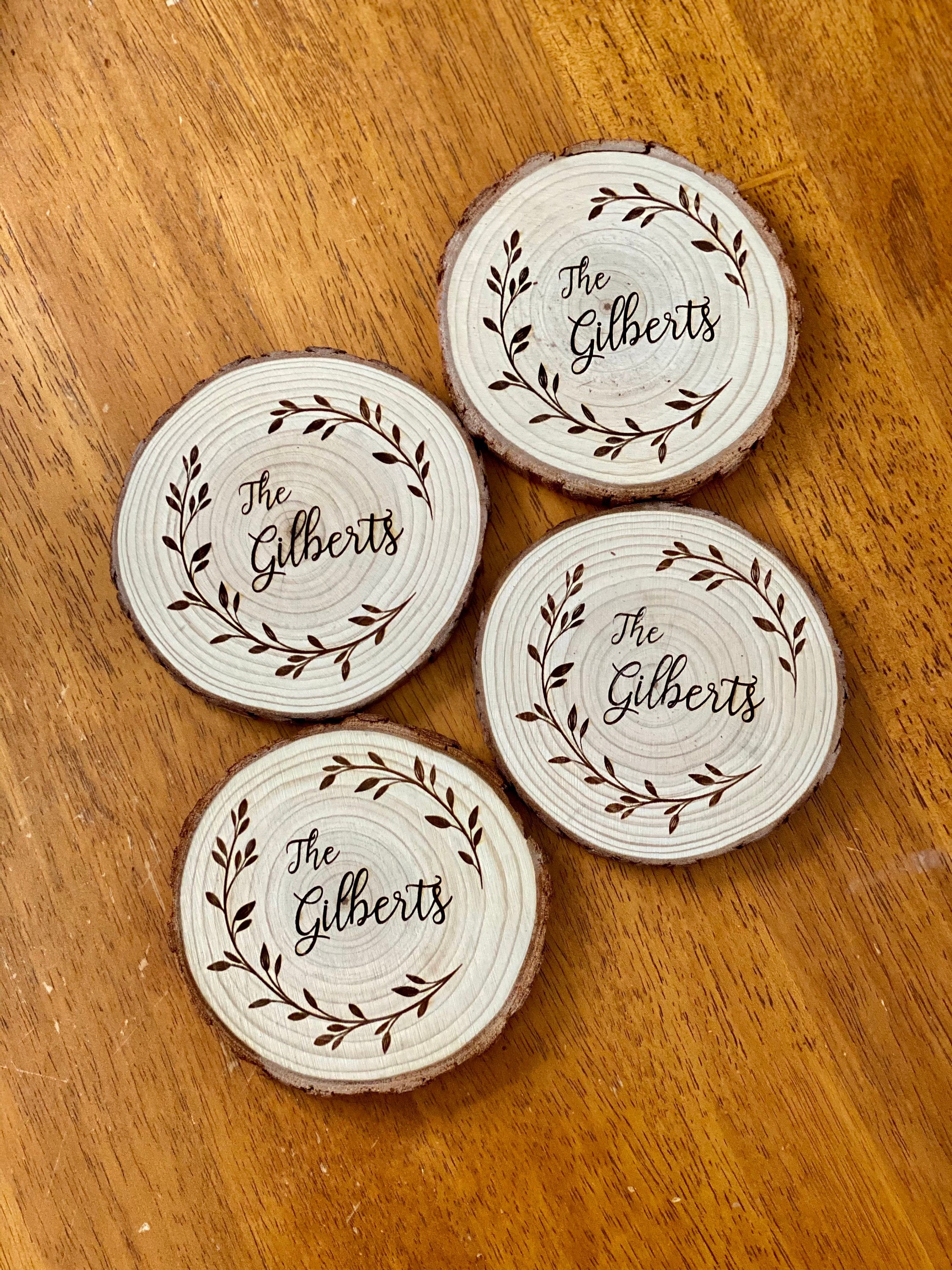 Custom family name engraved wood coasters set made from Californian Pine, showcasing rustic design and laser engraving.