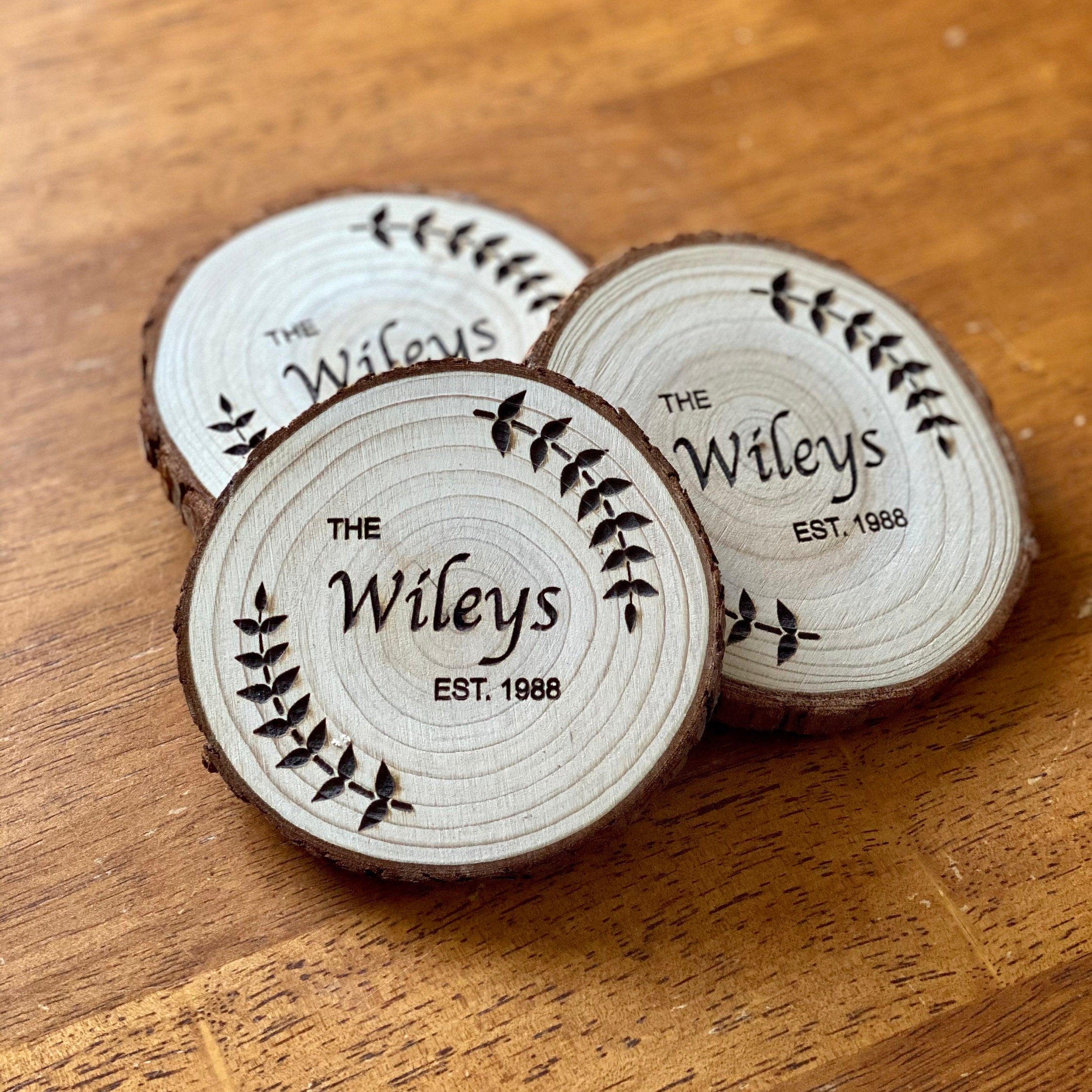 Custom wood coasters featuring engraved family name and year, made from Californian Pine, showcasing rustic charm.