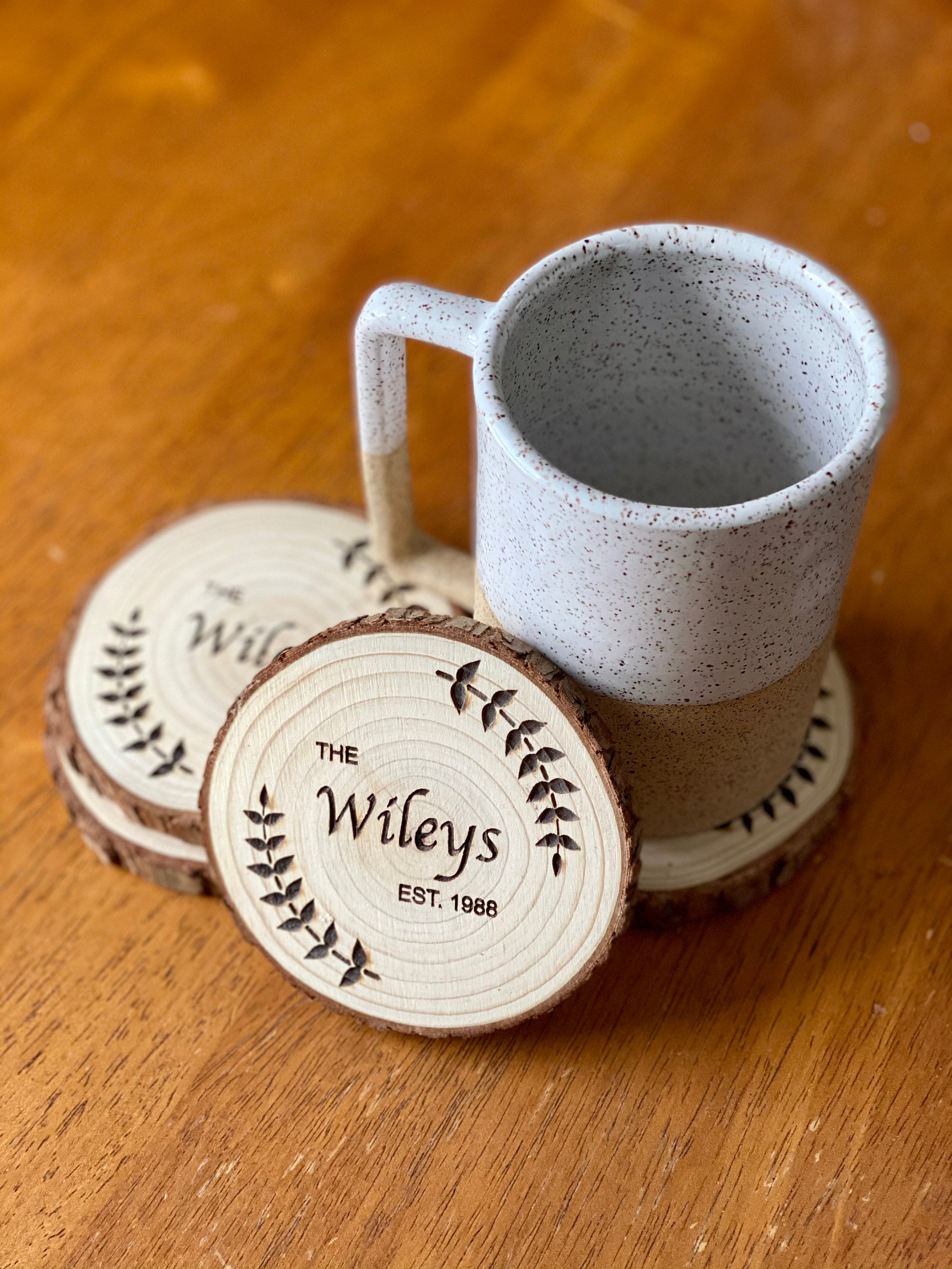 Custom wood coasters featuring engraved family name and year, made from Californian Pine, showcasing rustic charm.