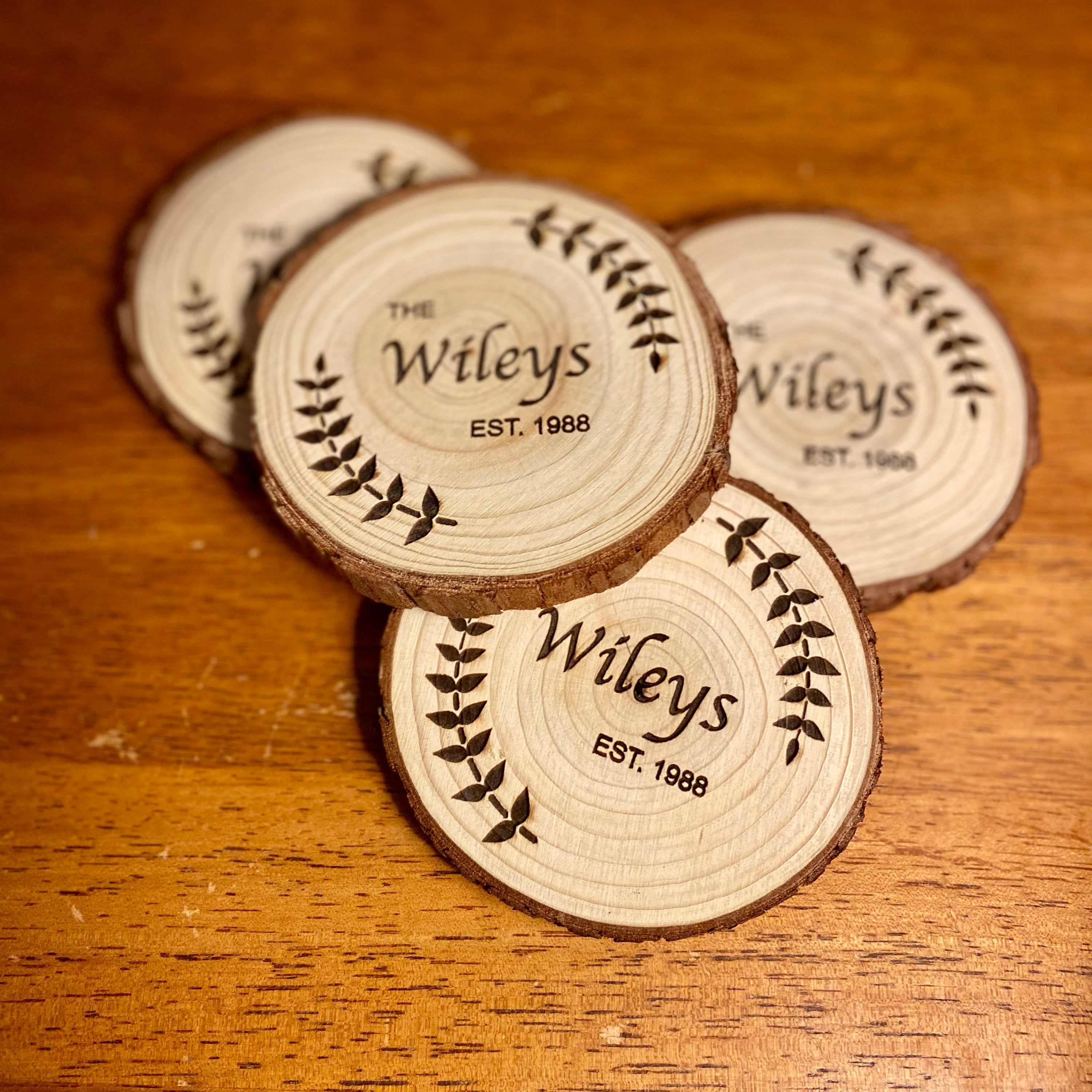 Custom wood coasters featuring engraved family name and year, made from Californian Pine, showcasing rustic charm.