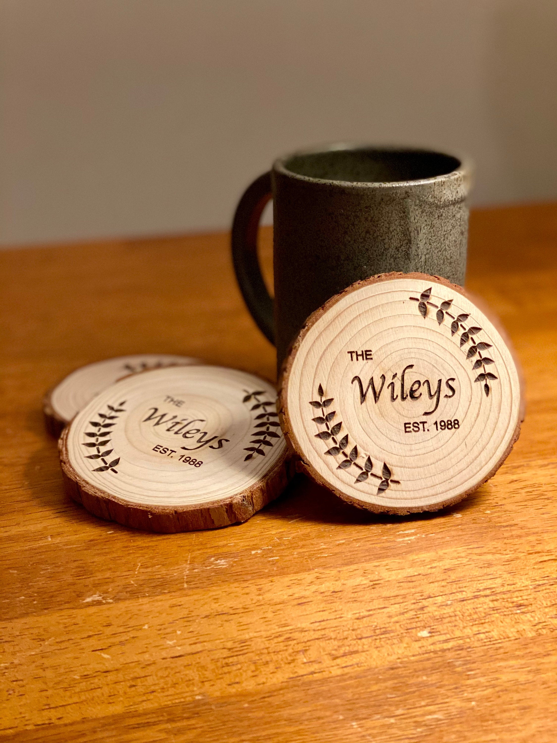 Custom wood coasters featuring engraved family name and year, made from Californian Pine, showcasing rustic charm.