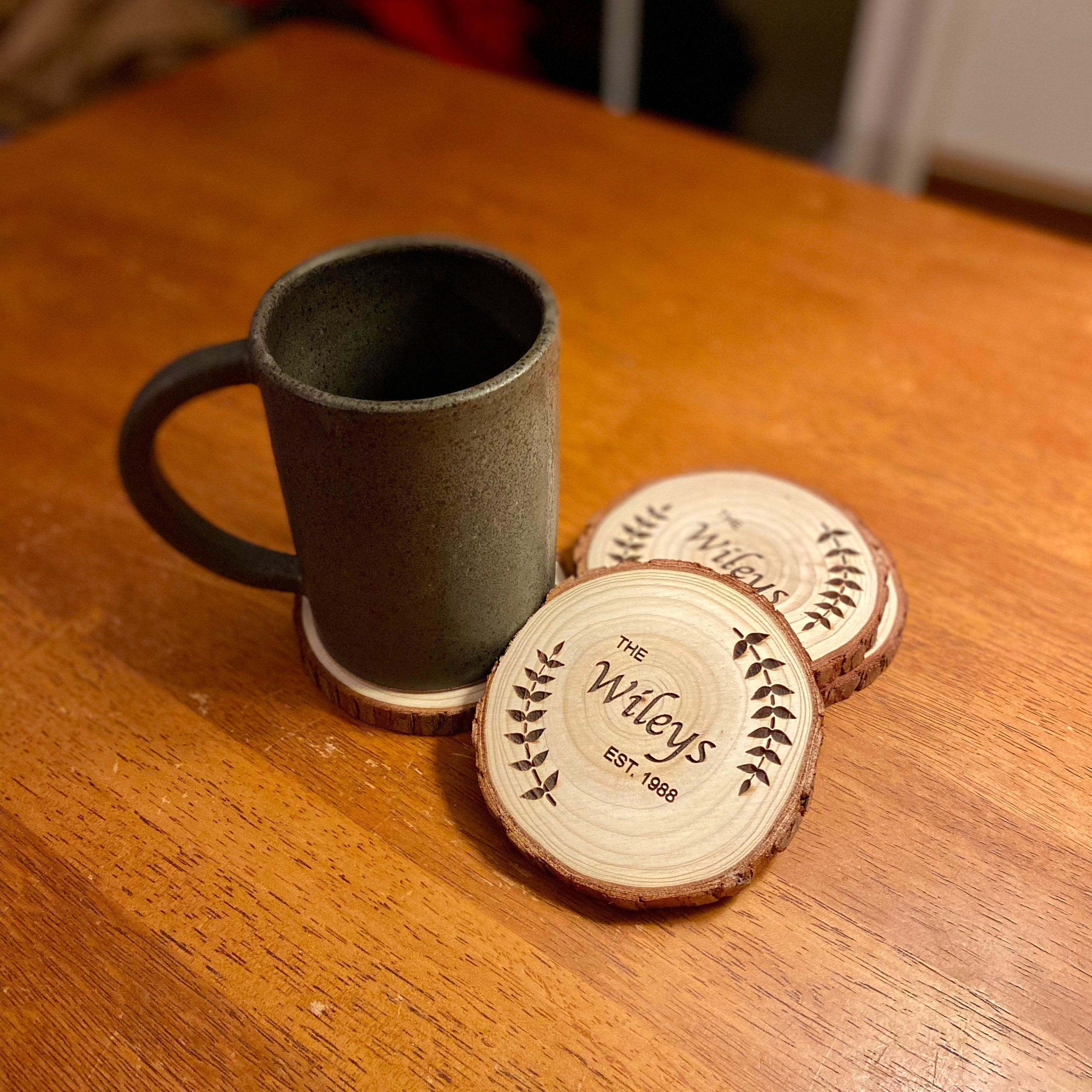 Custom wood coasters featuring engraved family name and year, made from Californian Pine, showcasing rustic charm.