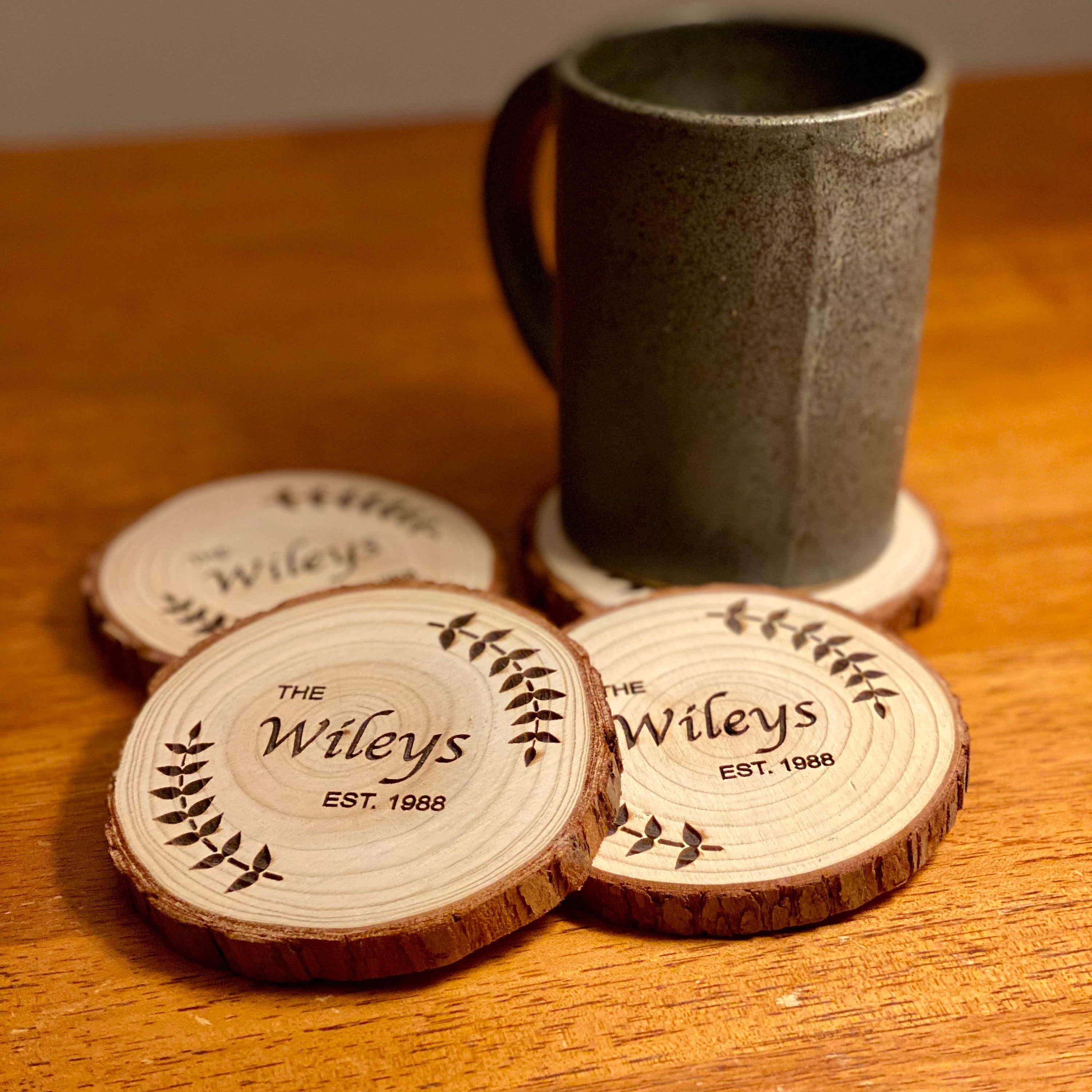 Custom wood coasters featuring engraved family name and year, made from Californian Pine, showcasing rustic charm.