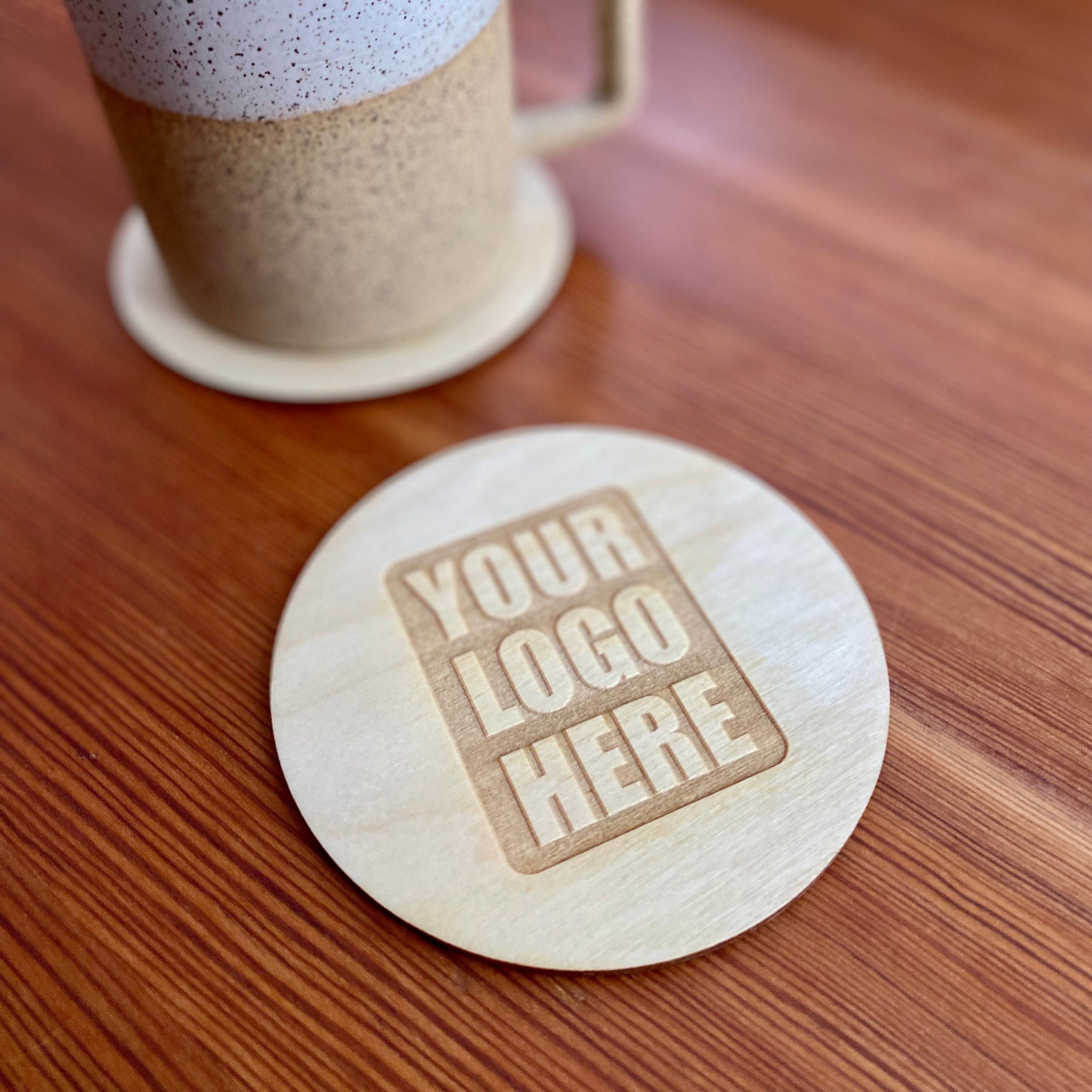 Set of custom logo wood coasters made from Baltic Birch, featuring laser engraved logos, perfect for corporate gifts and office use.