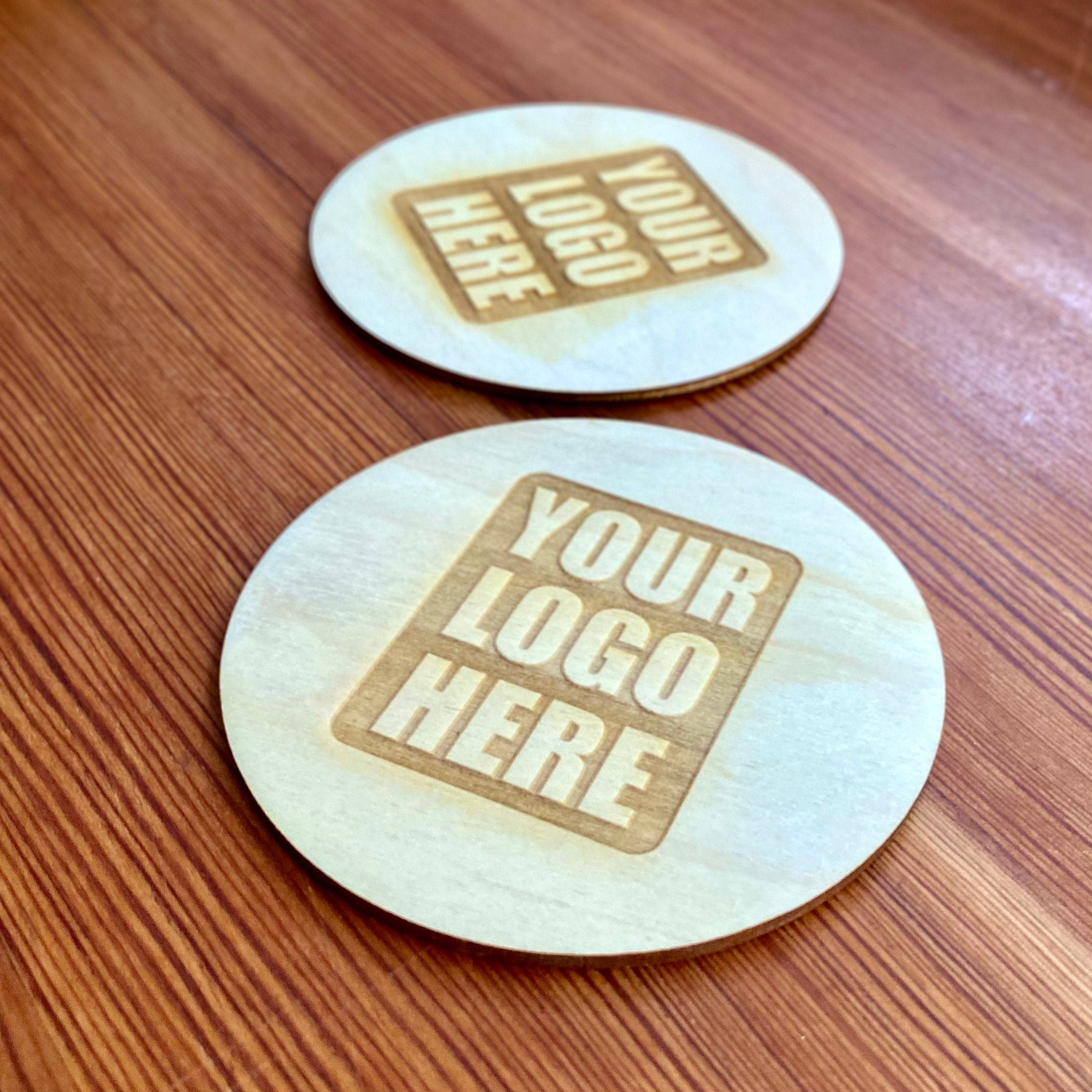 Set of custom logo wood coasters made from Baltic Birch, featuring laser engraved logos, perfect for corporate gifts and office use.