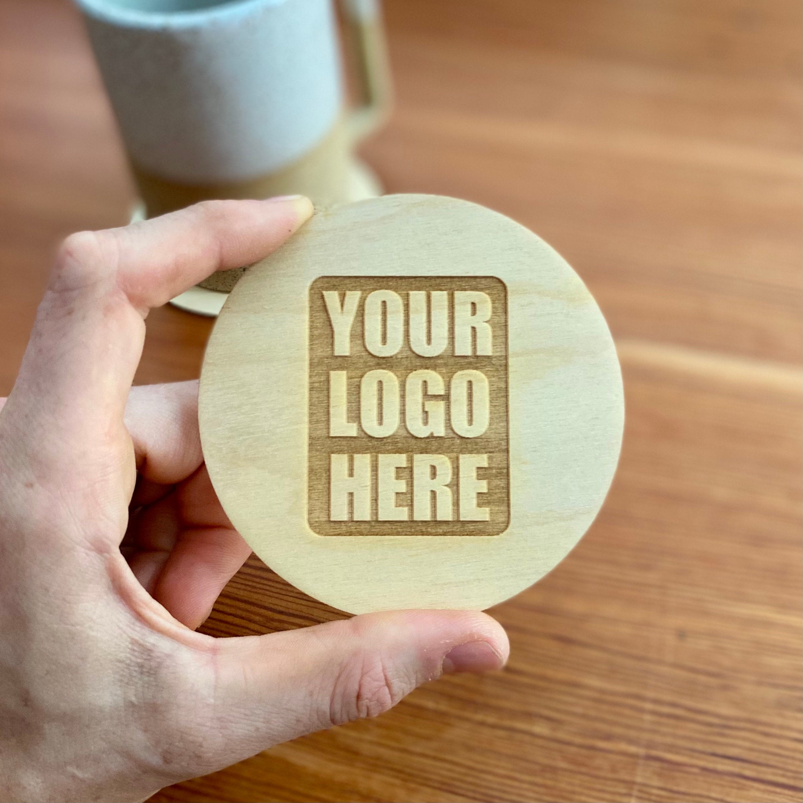 Set of custom logo wood coasters made from Baltic Birch, featuring laser engraved logos, perfect for corporate gifts and office use.