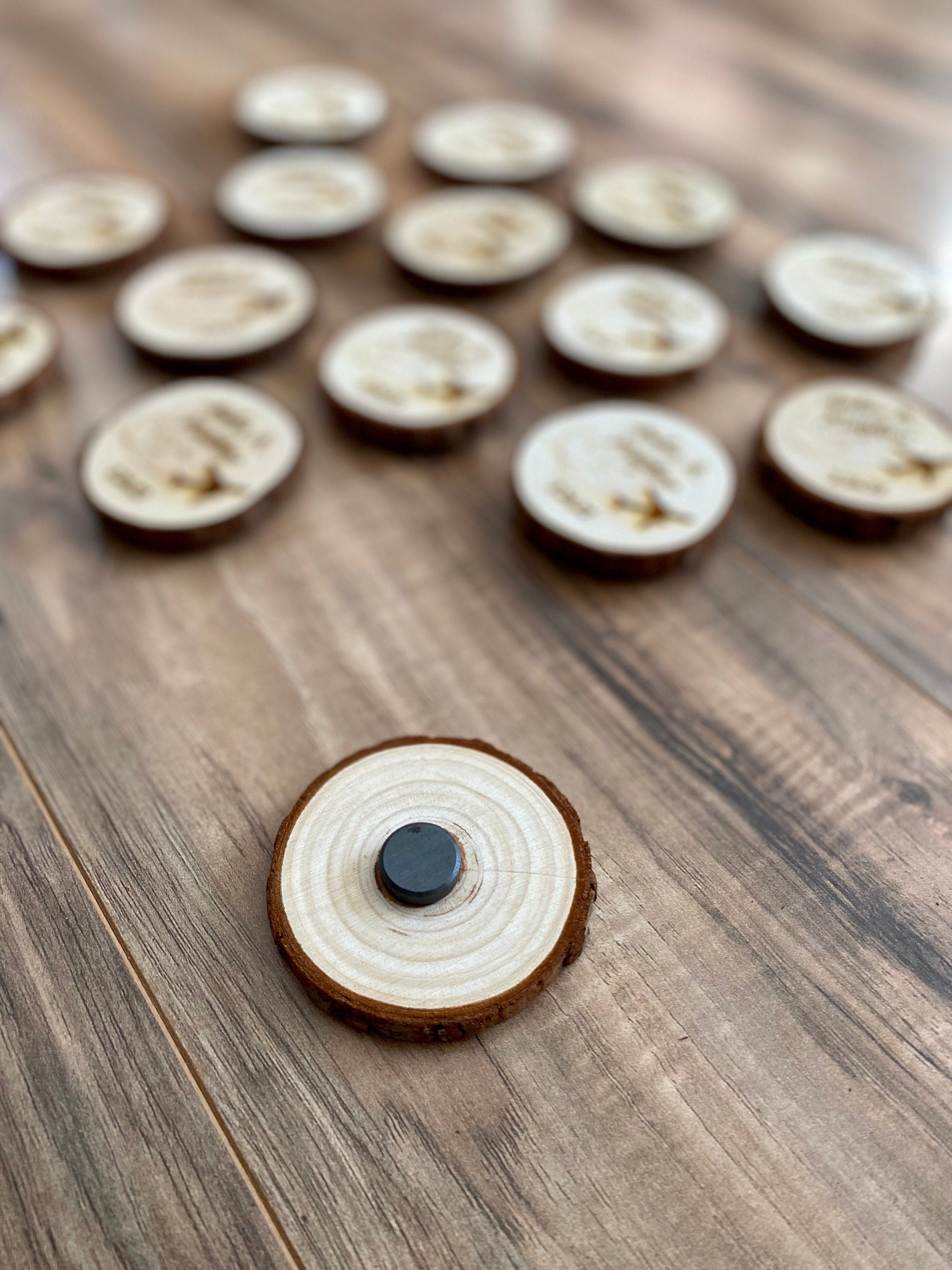 Personalized wood slice wedding favor featuring airplane design, engraved with couple's names and wedding date, with a magnet on the back.