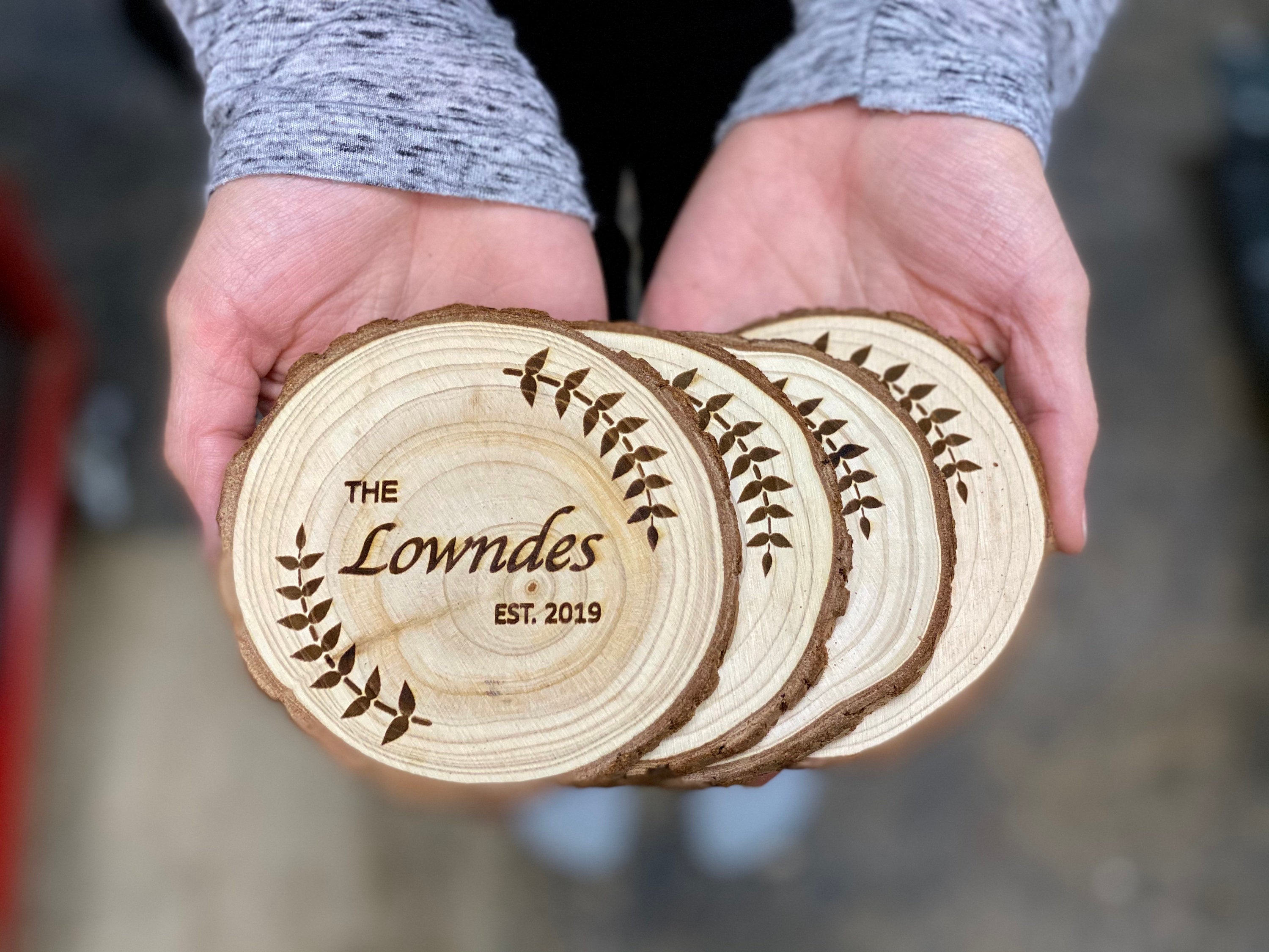 Personalized custom wood slice wedding favors with laser engraving, showcasing names and date.