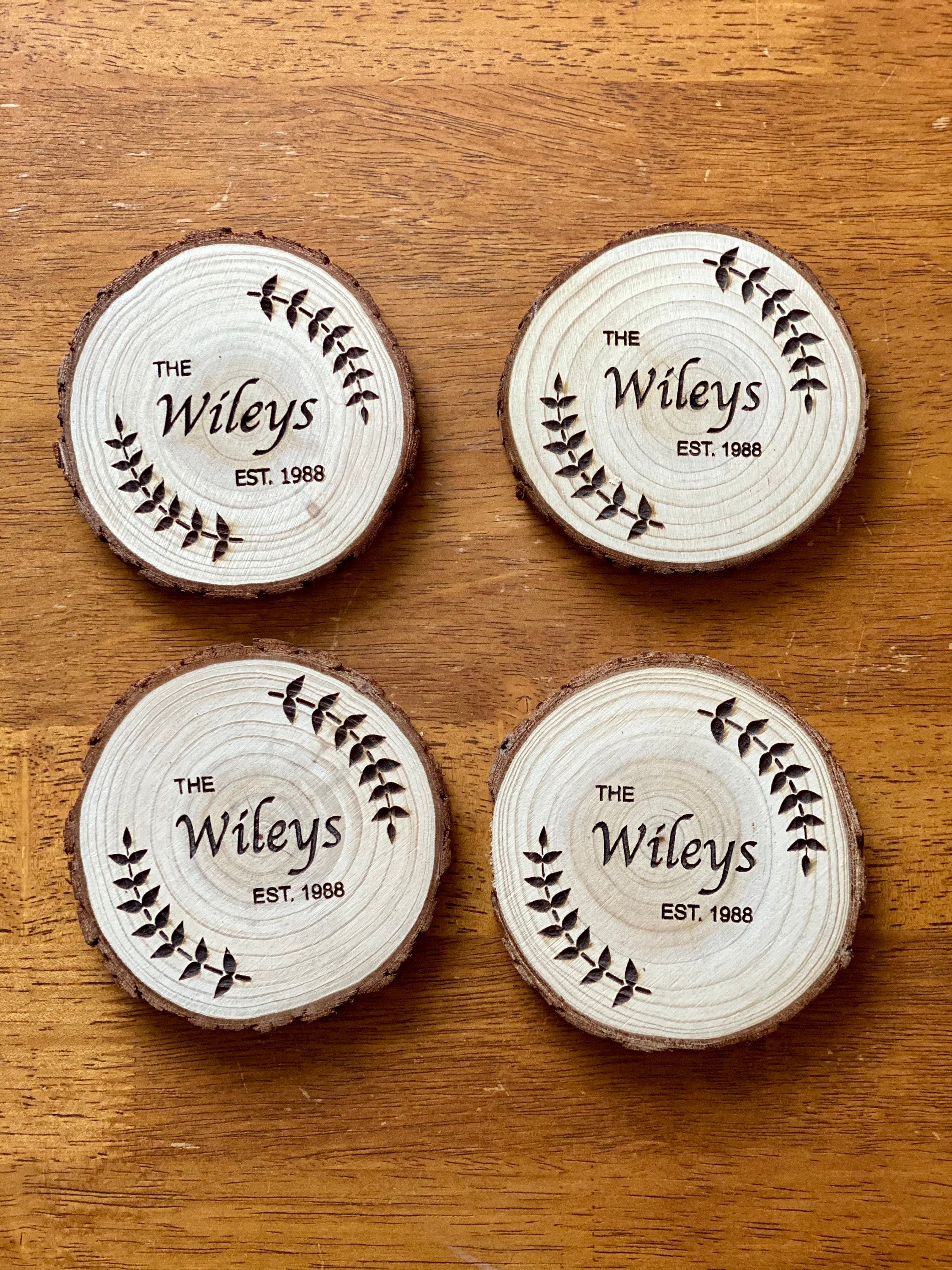 Personalized custom wood slice wedding favors with laser engraving, showcasing names and date.