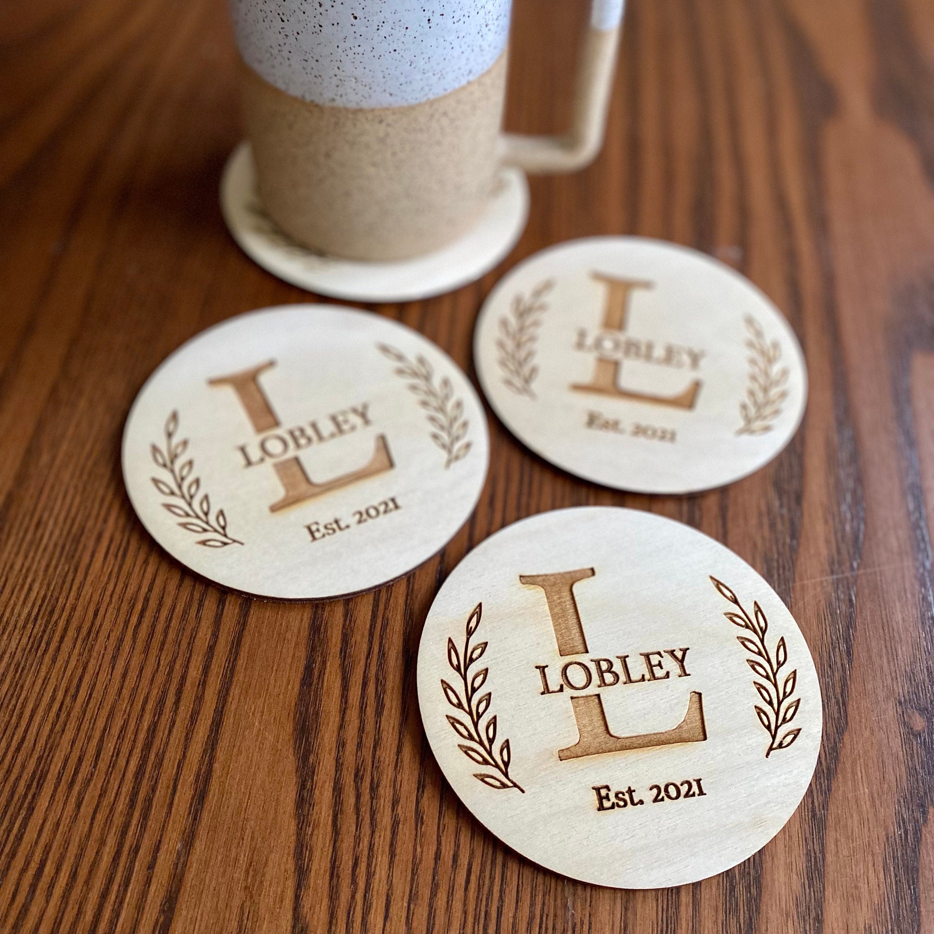 Engraved Monogram Wood Coaster Set featuring custom initials and leaf border design on Baltic Birch wood.