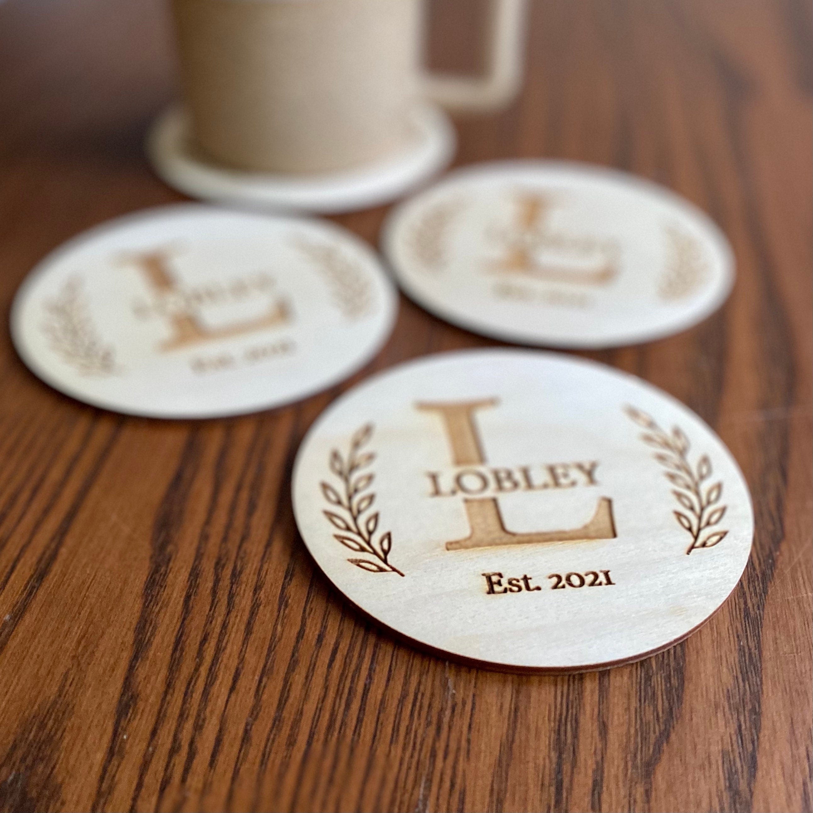 Engraved Monogram Wood Coaster Set featuring custom initials and leaf border design on Baltic Birch wood.