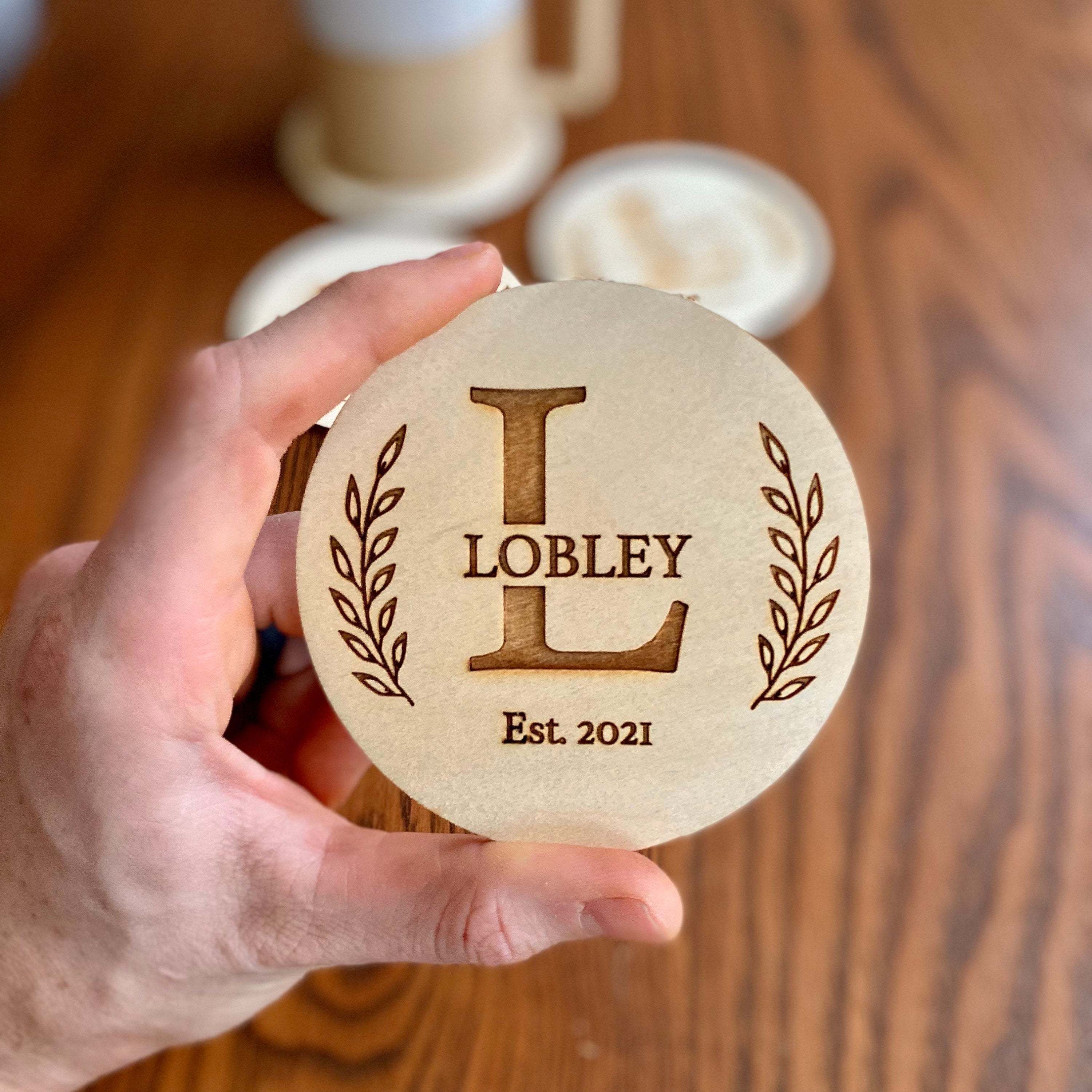 Engraved Monogram Wood Coaster Set featuring custom initials and leaf border design on Baltic Birch wood.