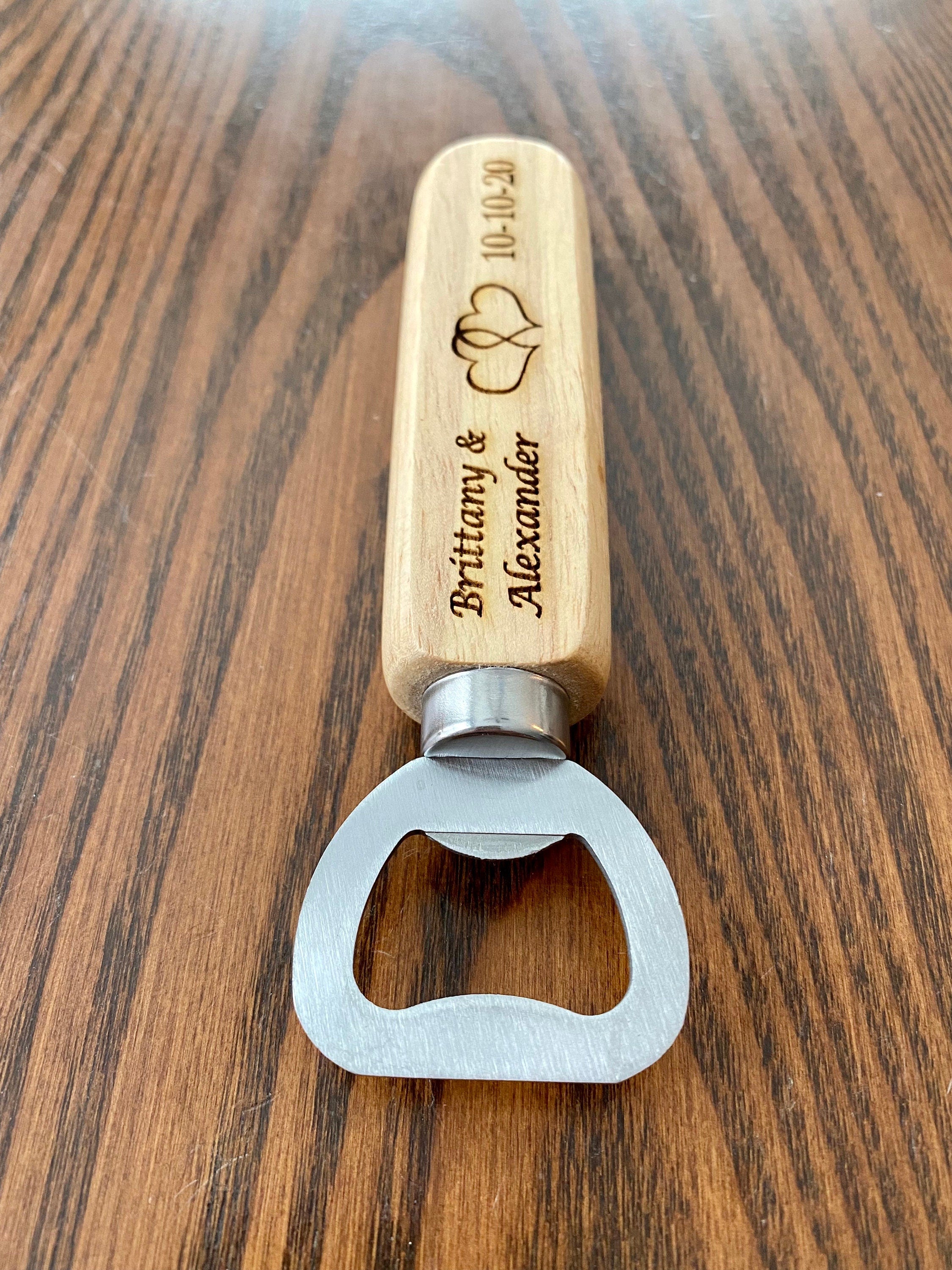 Personalized engraved wood bottle opener with heart design, perfect for weddings.