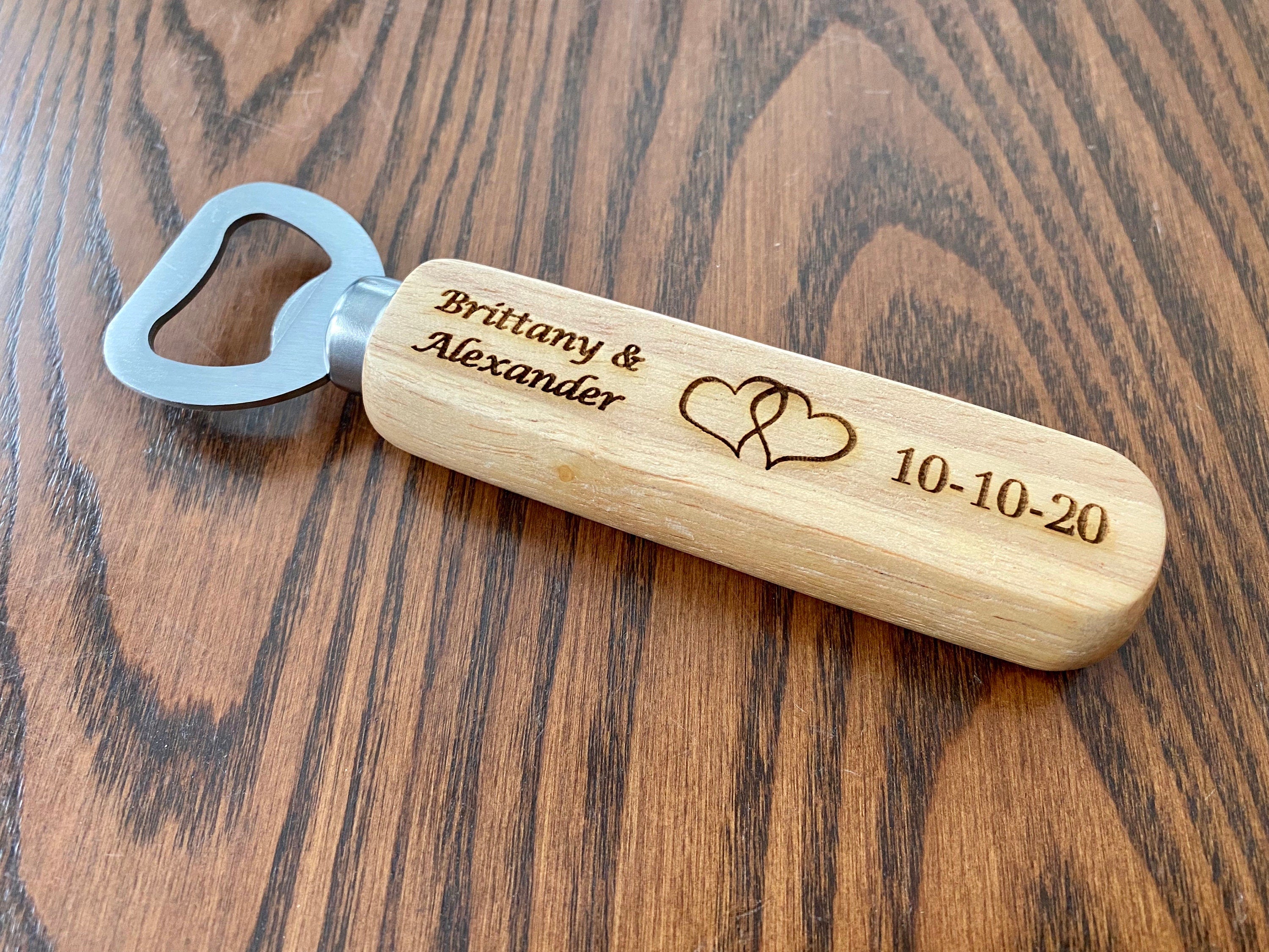 Personalized engraved wood bottle opener with heart design, perfect for weddings.