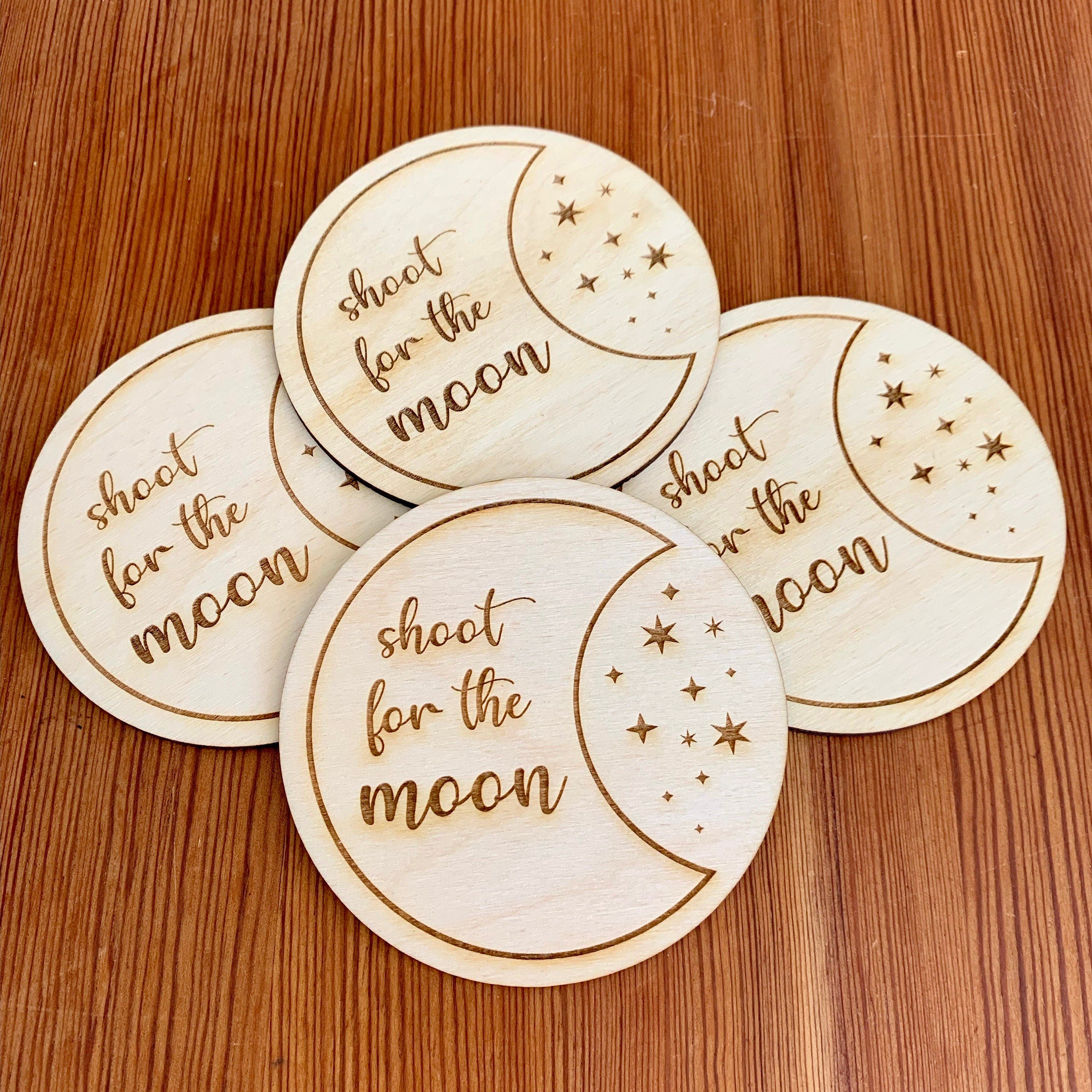 Engraved wood coasters featuring a moon and stars design, made from Baltic Birch, showcasing a rustic yet refined look.