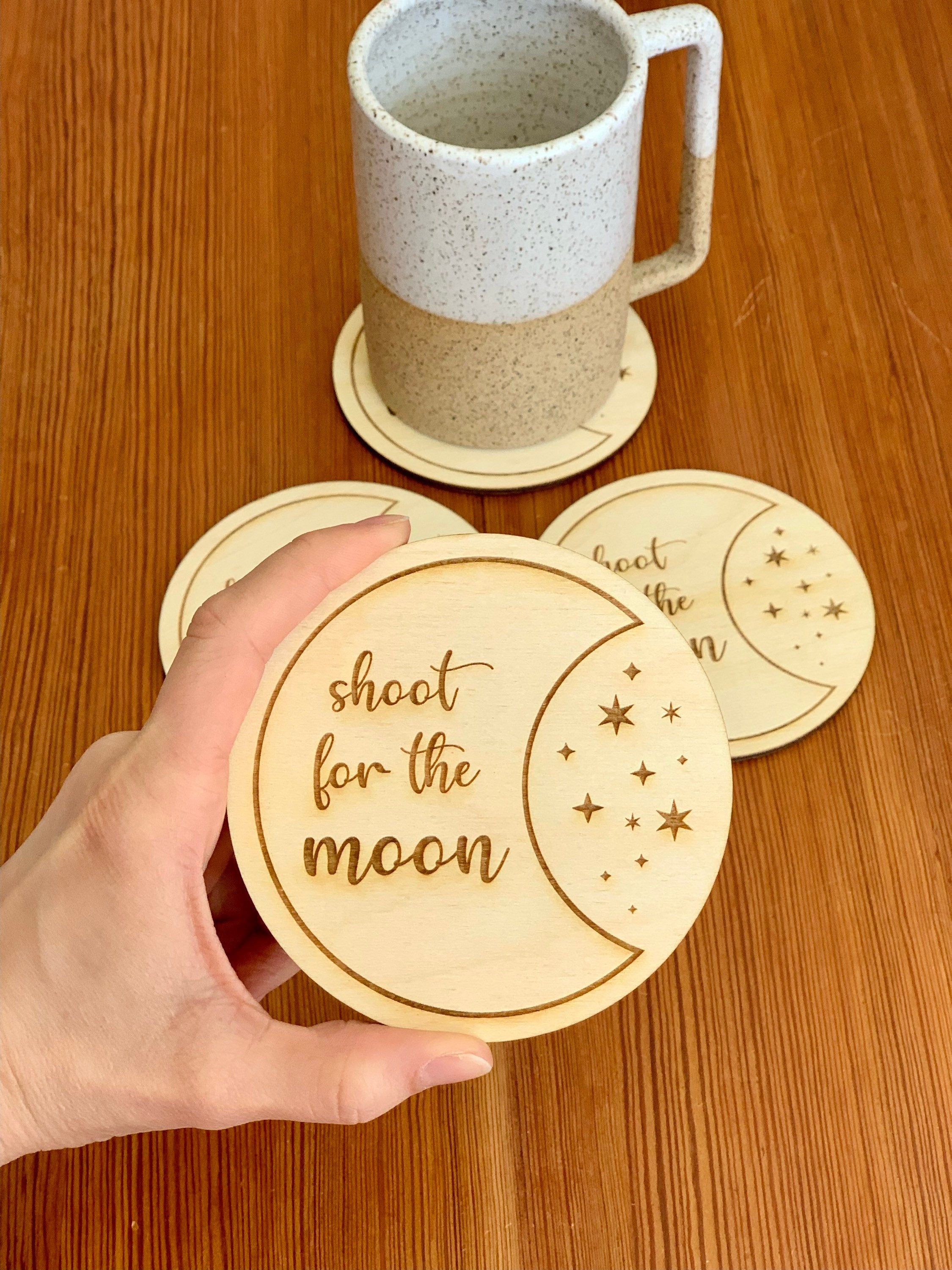 Engraved wood coasters featuring a moon and stars design, made from Baltic Birch, showcasing a rustic yet refined look.