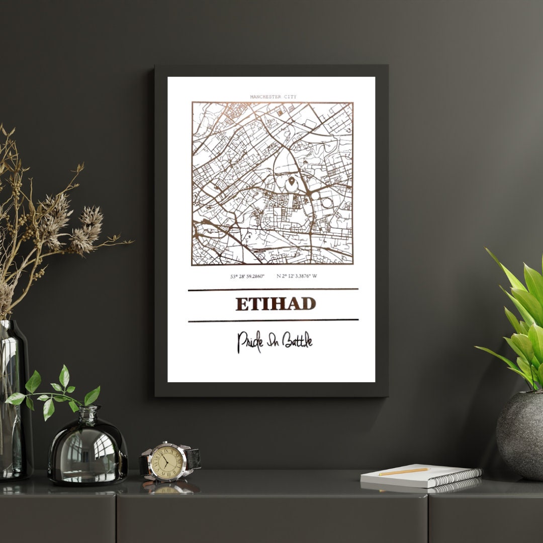 Etihad Foil Map Print featuring intricate foil detailing of Manchester City's stadium, showcasing coordinates and slogan.