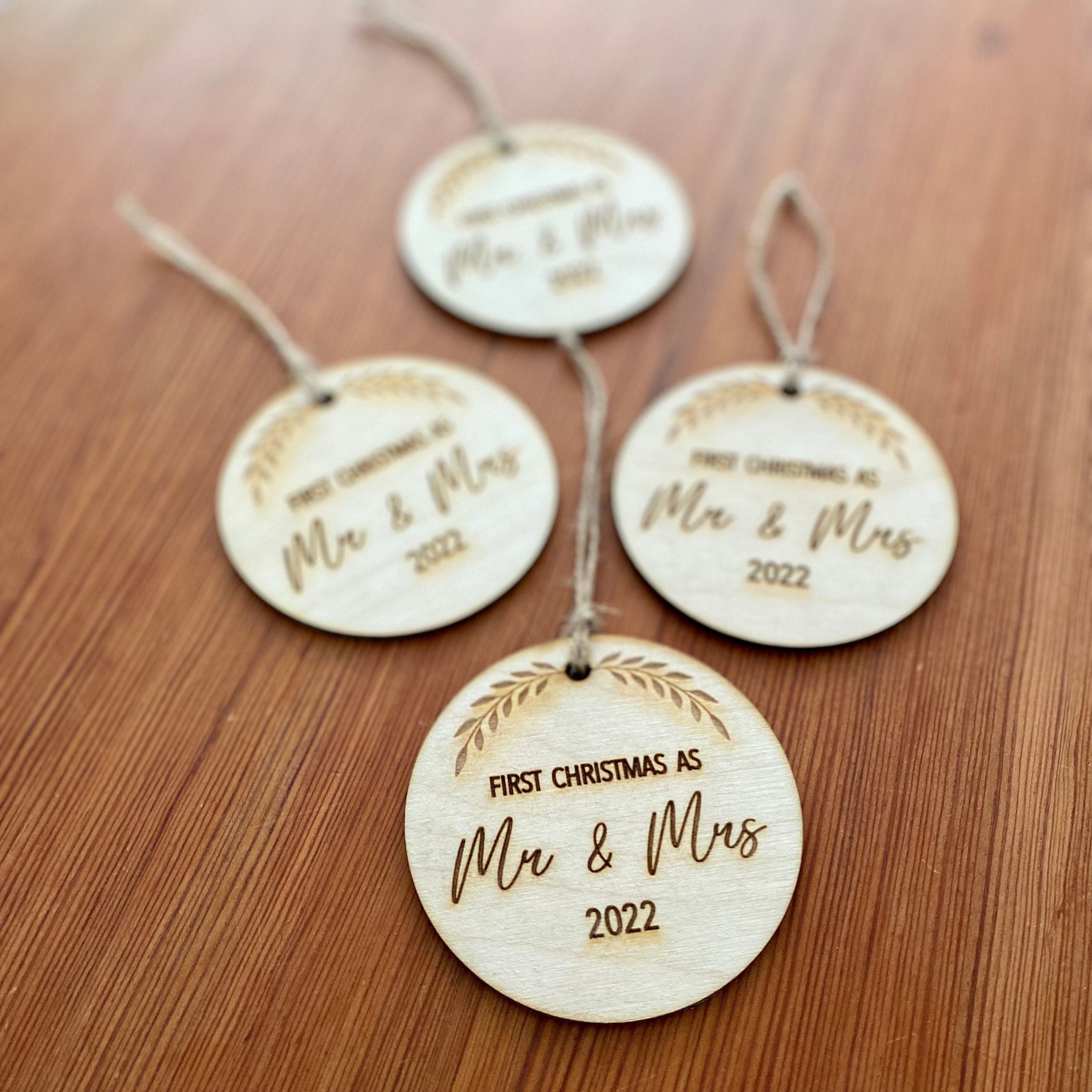 Rustic laser engraved wood slice ornament for first Christmas married, featuring a customizable year.