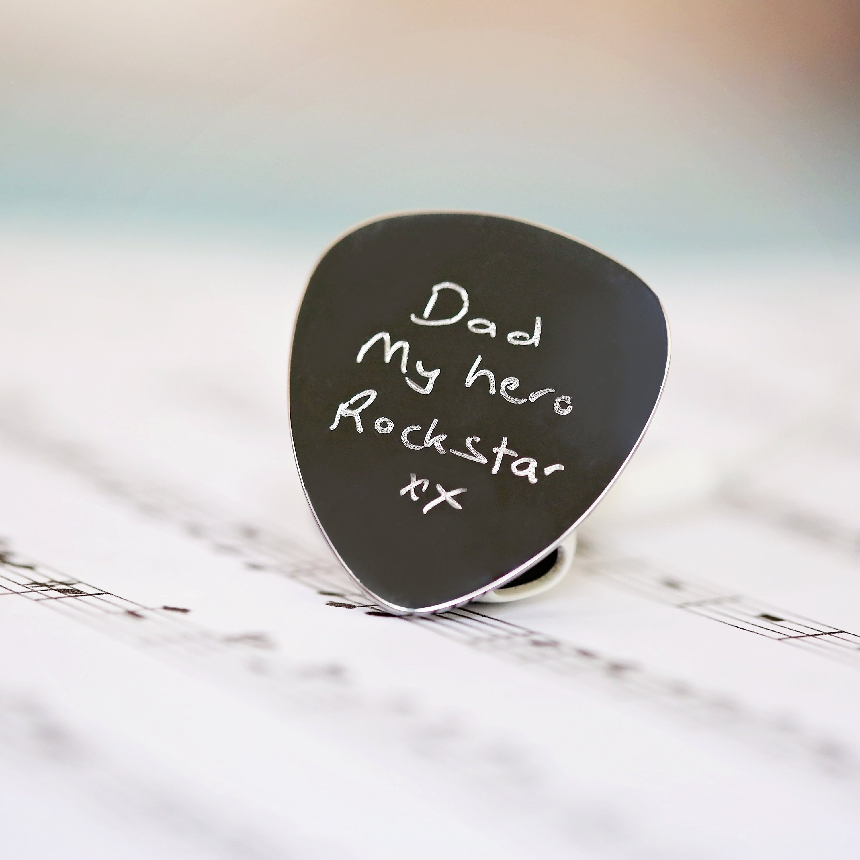 Personalised Handwriting Engraving Guitar Pick in a gift box with satin ribbon and blue zig-zag shred.