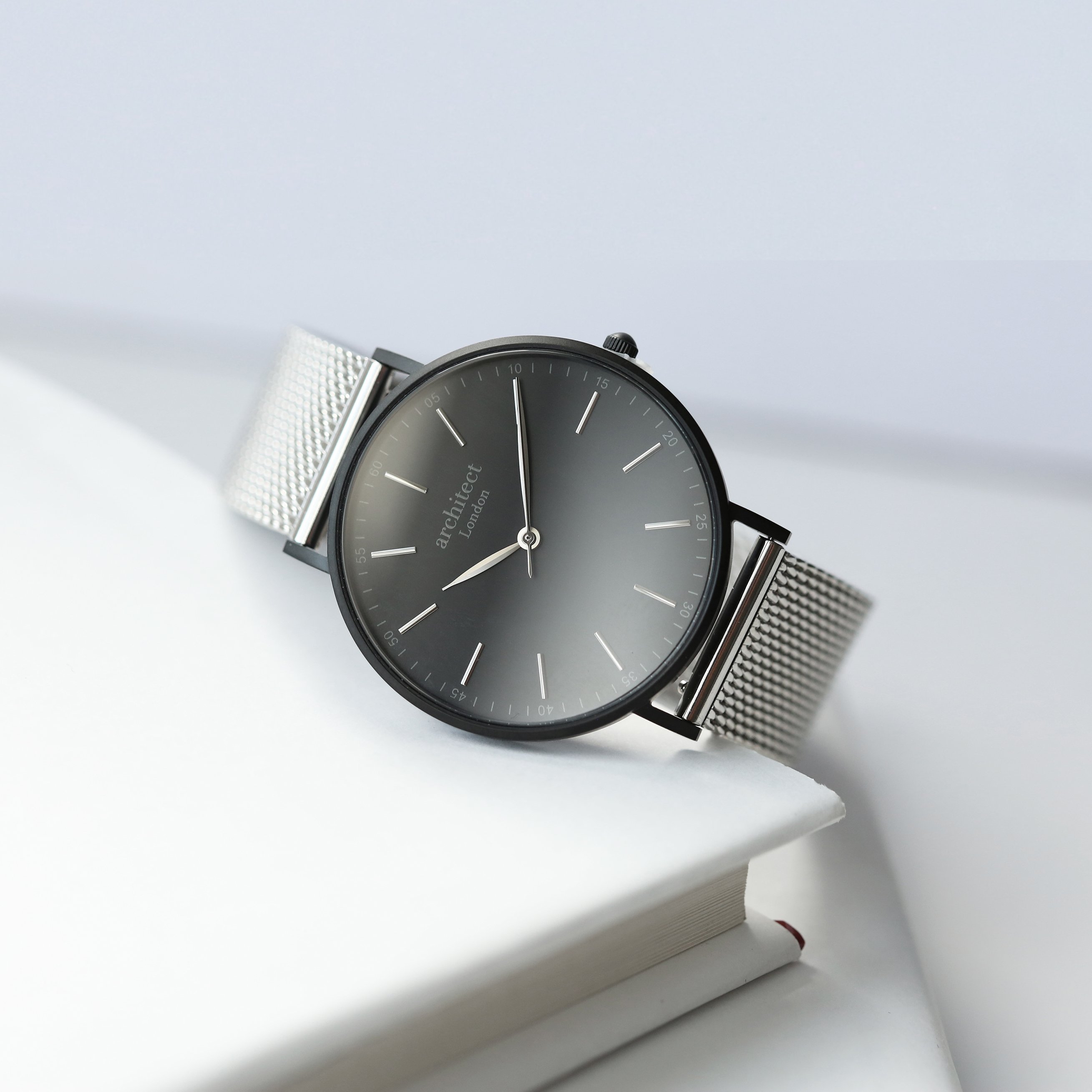 Men's minimalist watch with steel silver mesh strap and personalized handwriting engraving on the back.