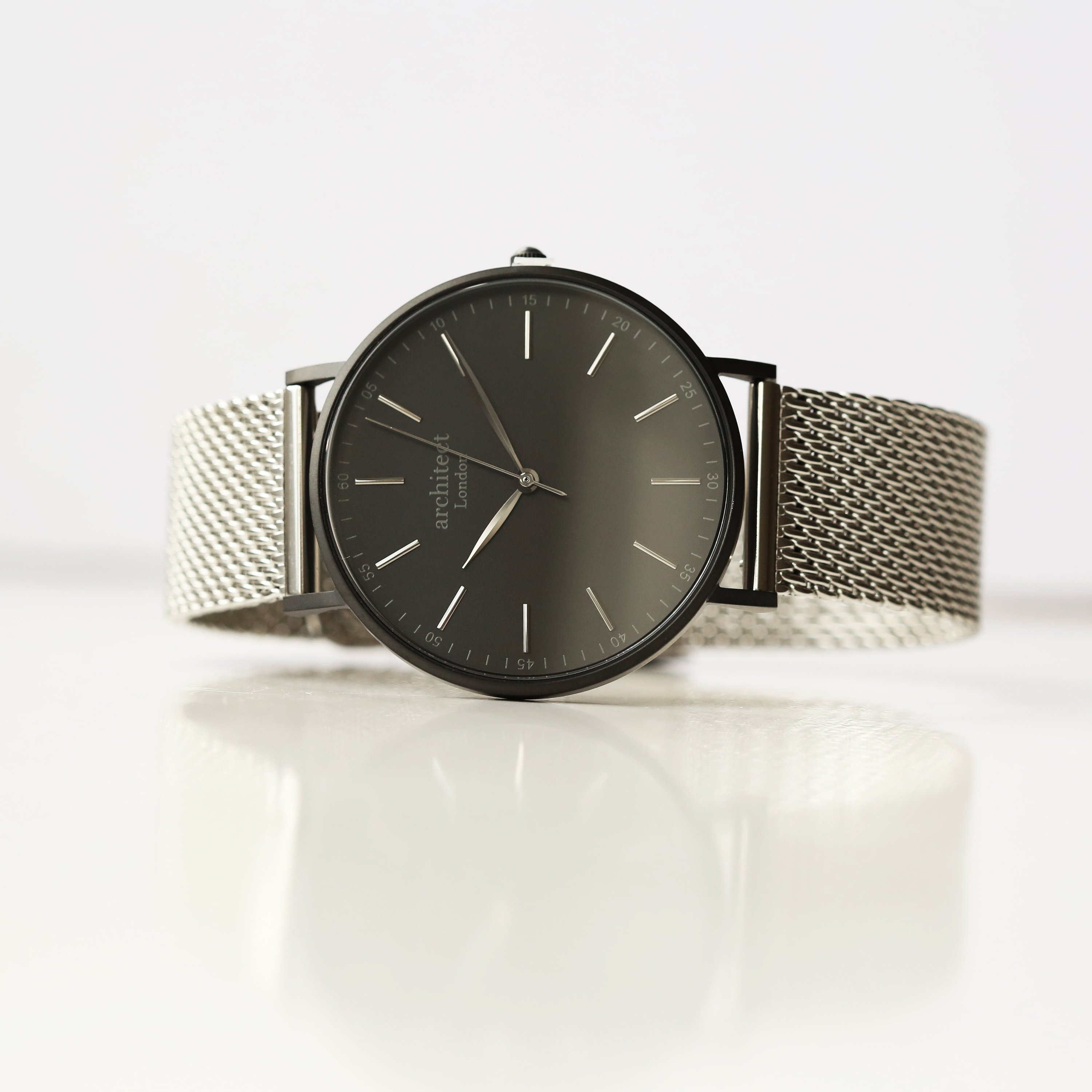 Men's minimalist watch with steel silver mesh strap and personalized handwriting engraving on the back.