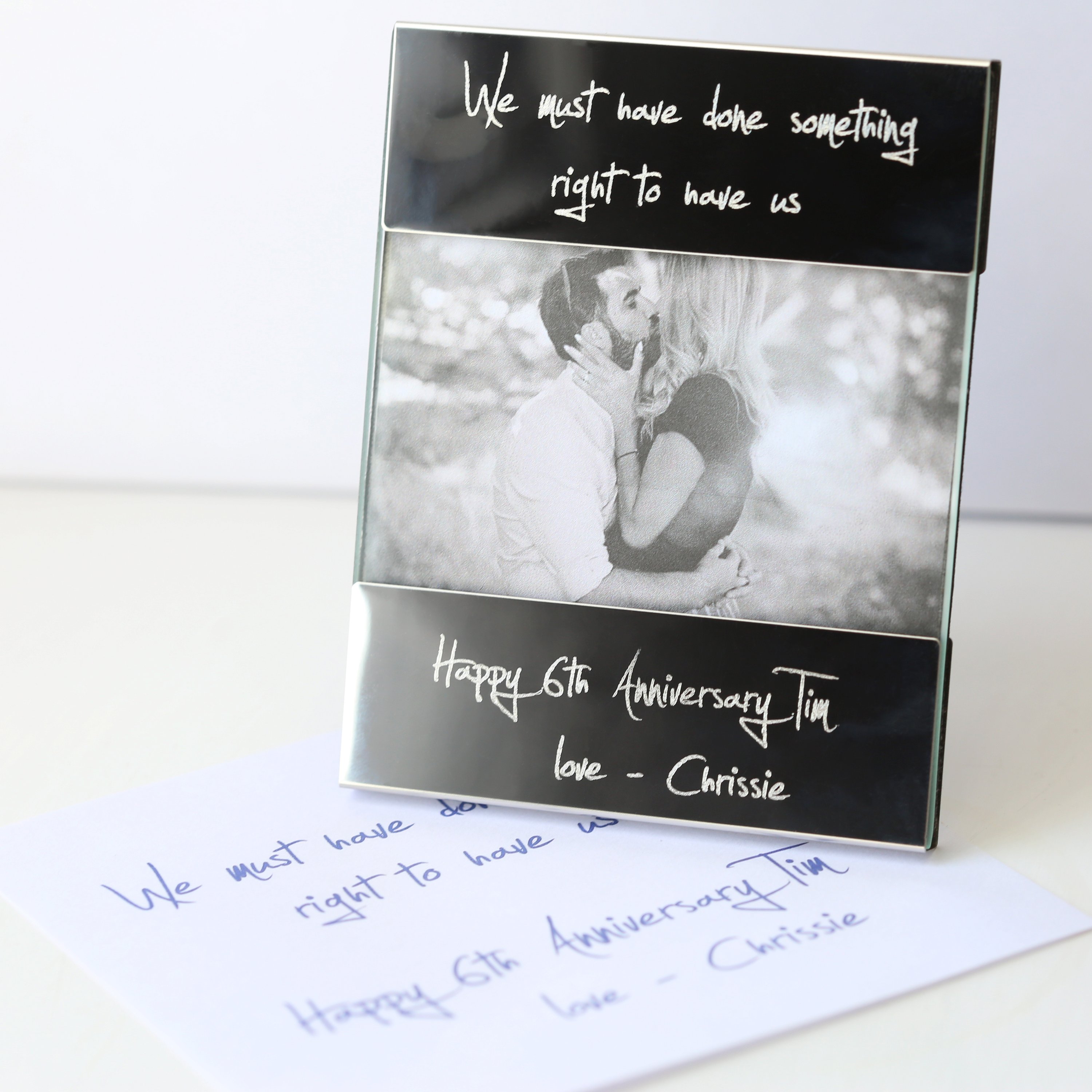 A modern Handwriting Engraving Photo Frame made of polished stainless steel, showcasing a personalized engraving with handwritten message.