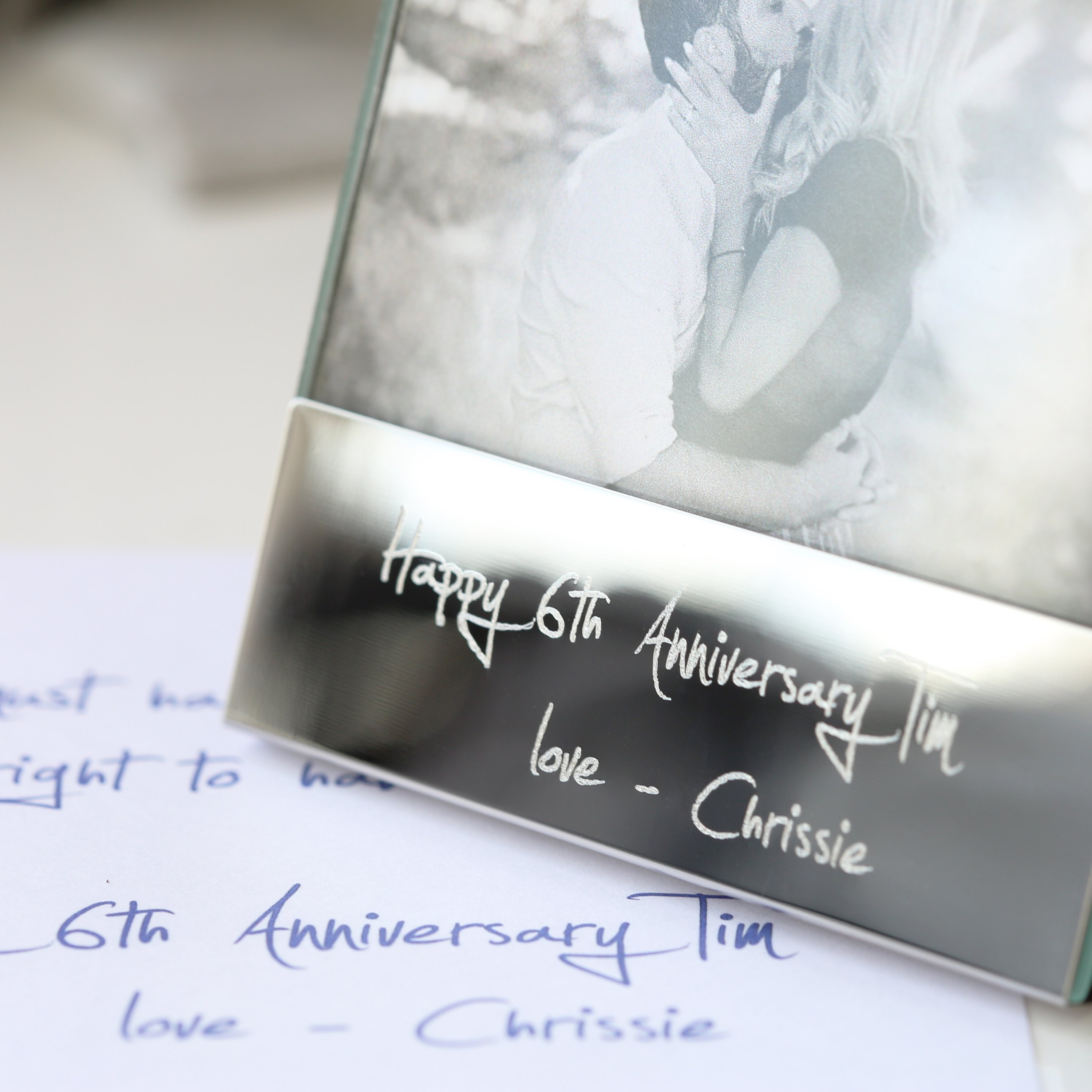 A modern Handwriting Engraving Photo Frame made of polished stainless steel, showcasing a personalized engraving with handwritten message.