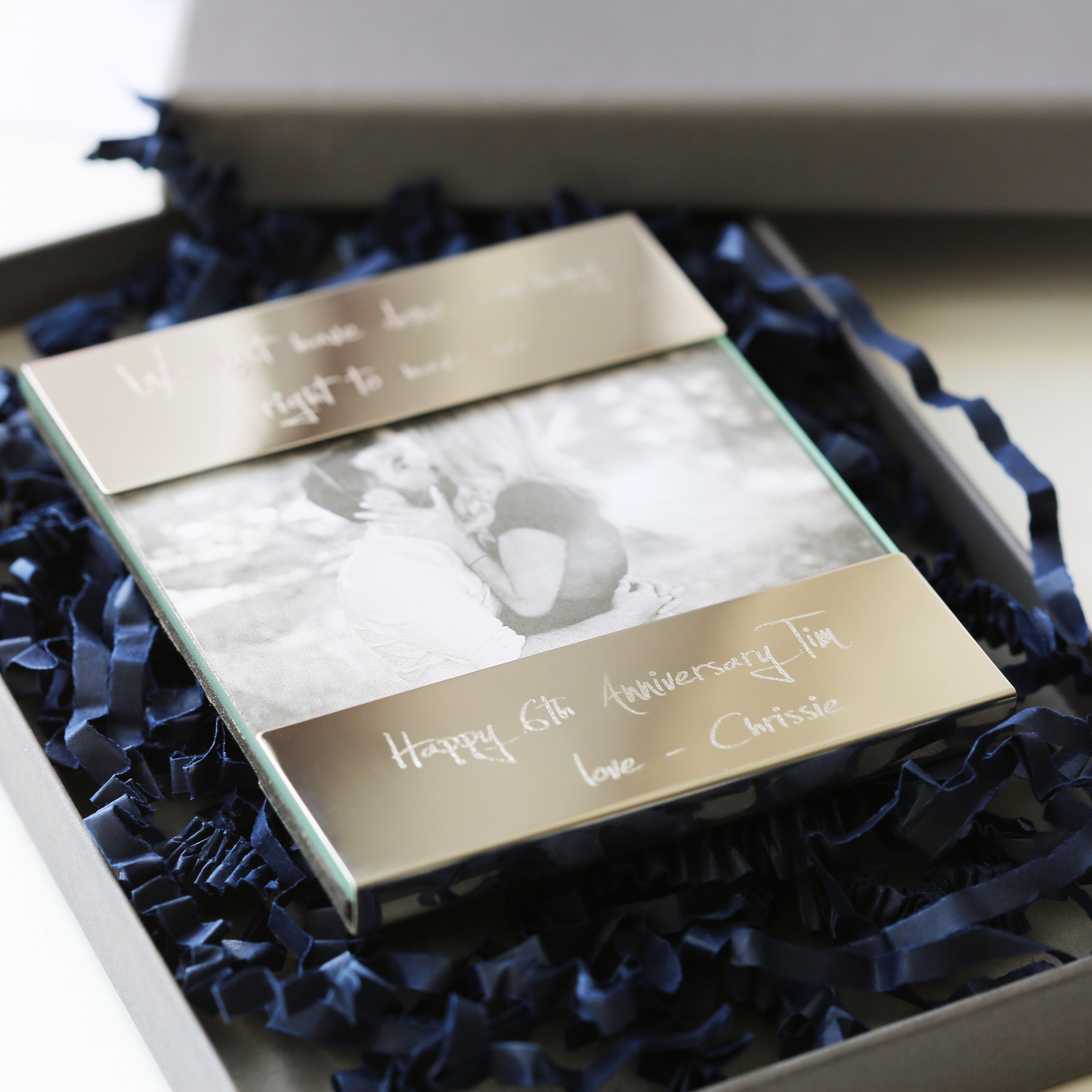 A modern Handwriting Engraving Photo Frame made of polished stainless steel, showcasing a personalized engraving with handwritten message.