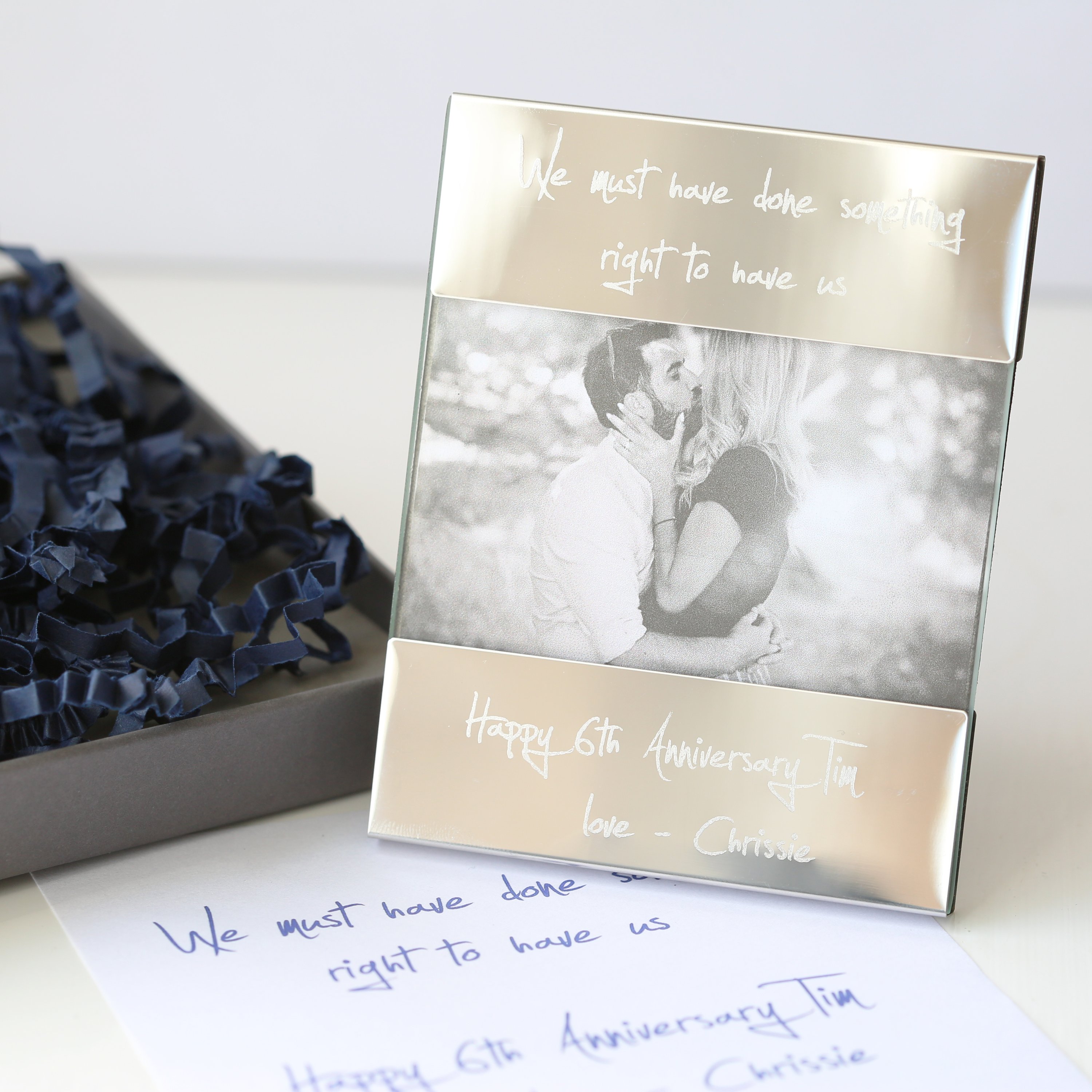 A modern Handwriting Engraving Photo Frame made of polished stainless steel, showcasing a personalized engraving with handwritten message.