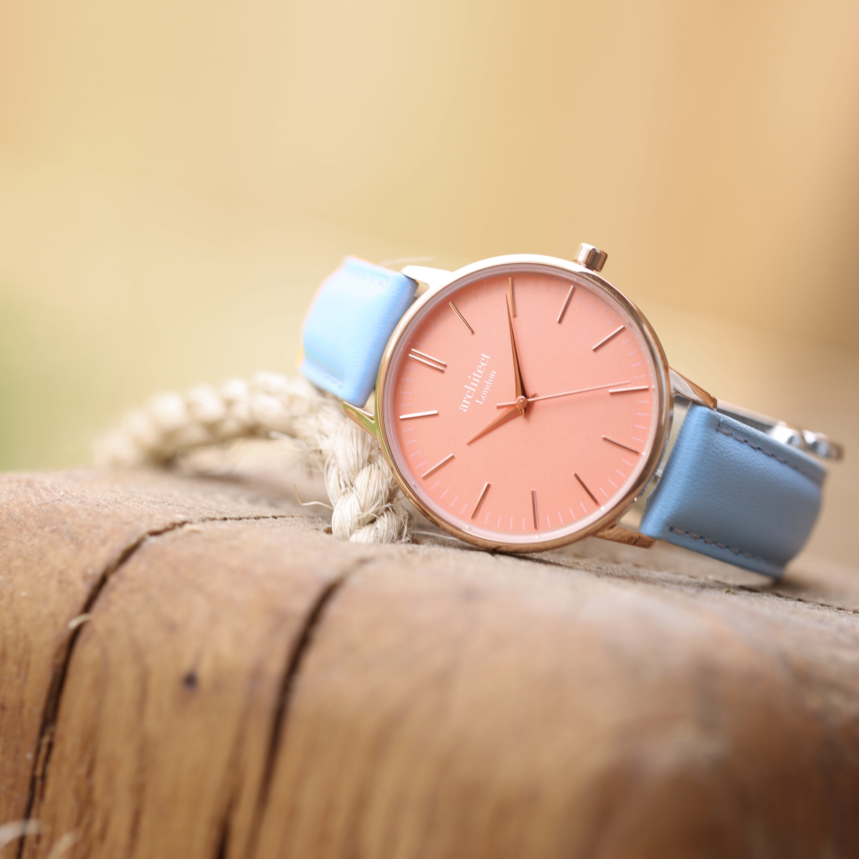 Ladies Architēct Coral watch featuring handwriting engraving and a light blue genuine leather strap, showcasing a stylish apricot coral dial.