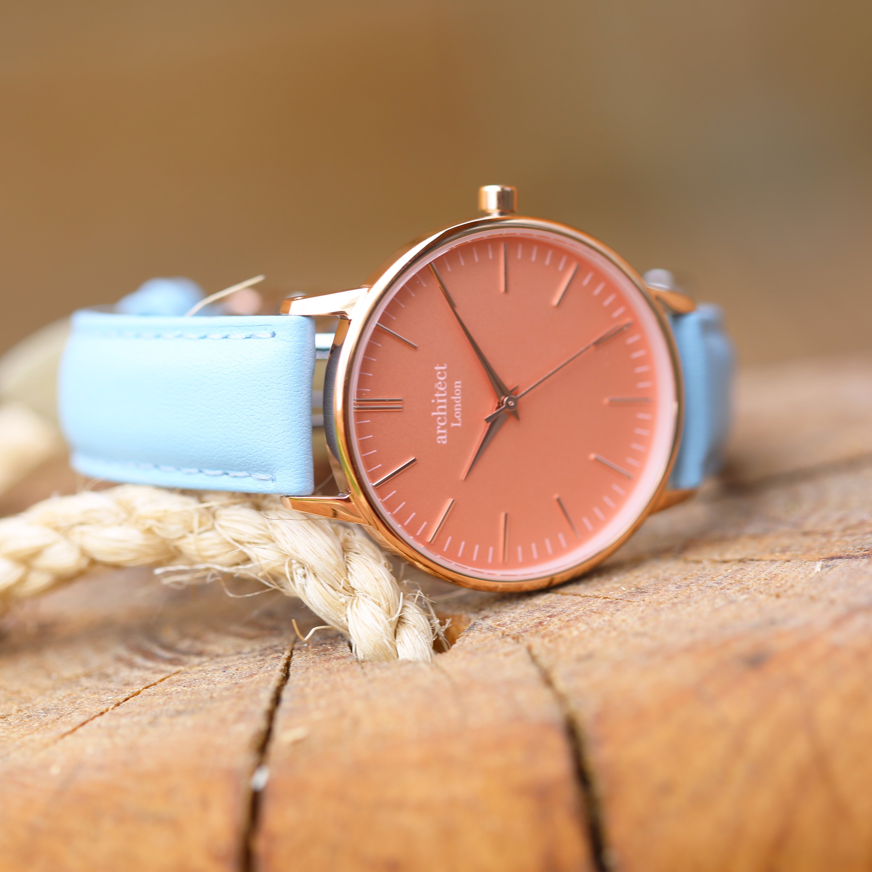 Ladies Architēct Coral watch featuring handwriting engraving and a light blue genuine leather strap, showcasing a stylish apricot coral dial.