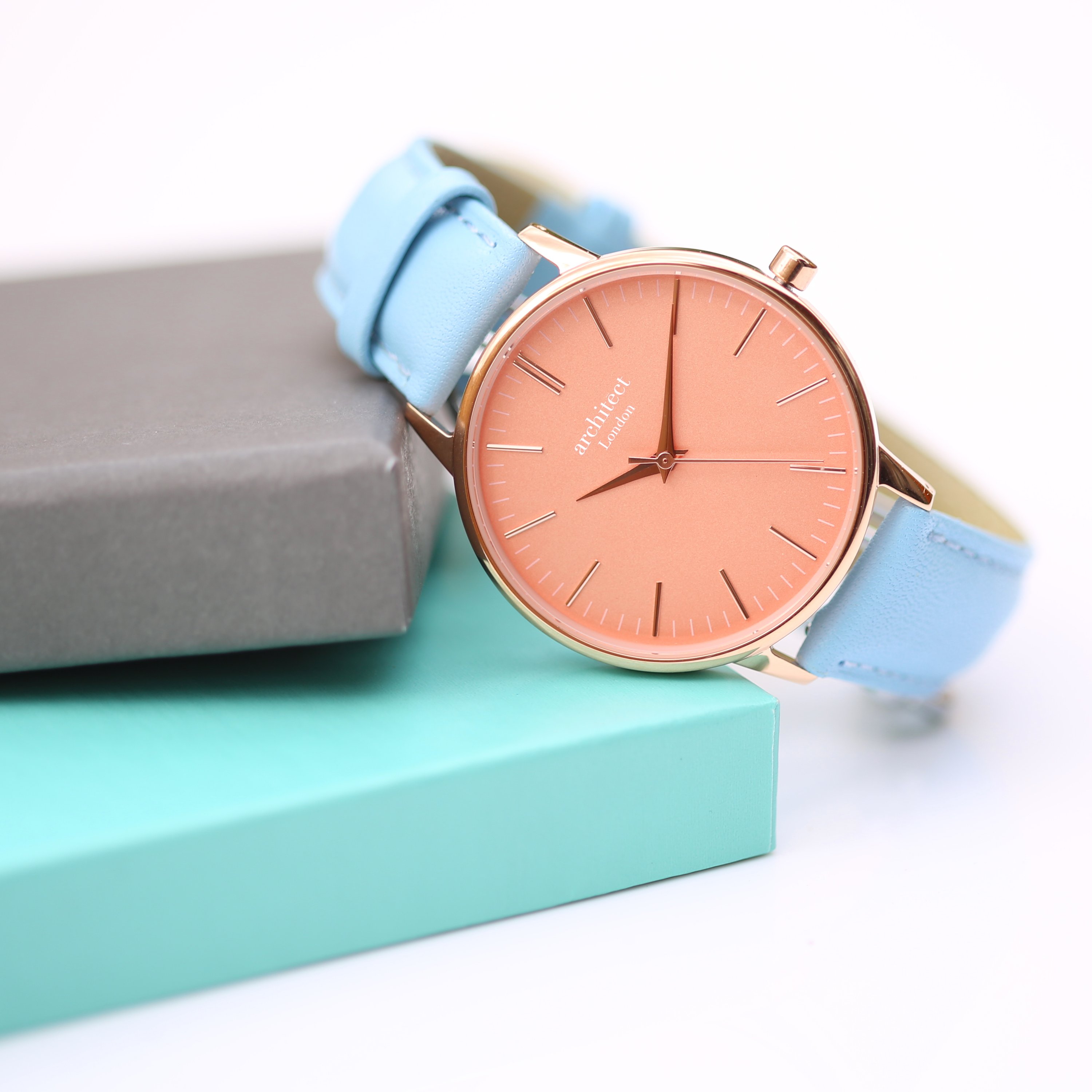 Ladies Architēct Coral watch featuring handwriting engraving and a light blue genuine leather strap, showcasing a stylish apricot coral dial.