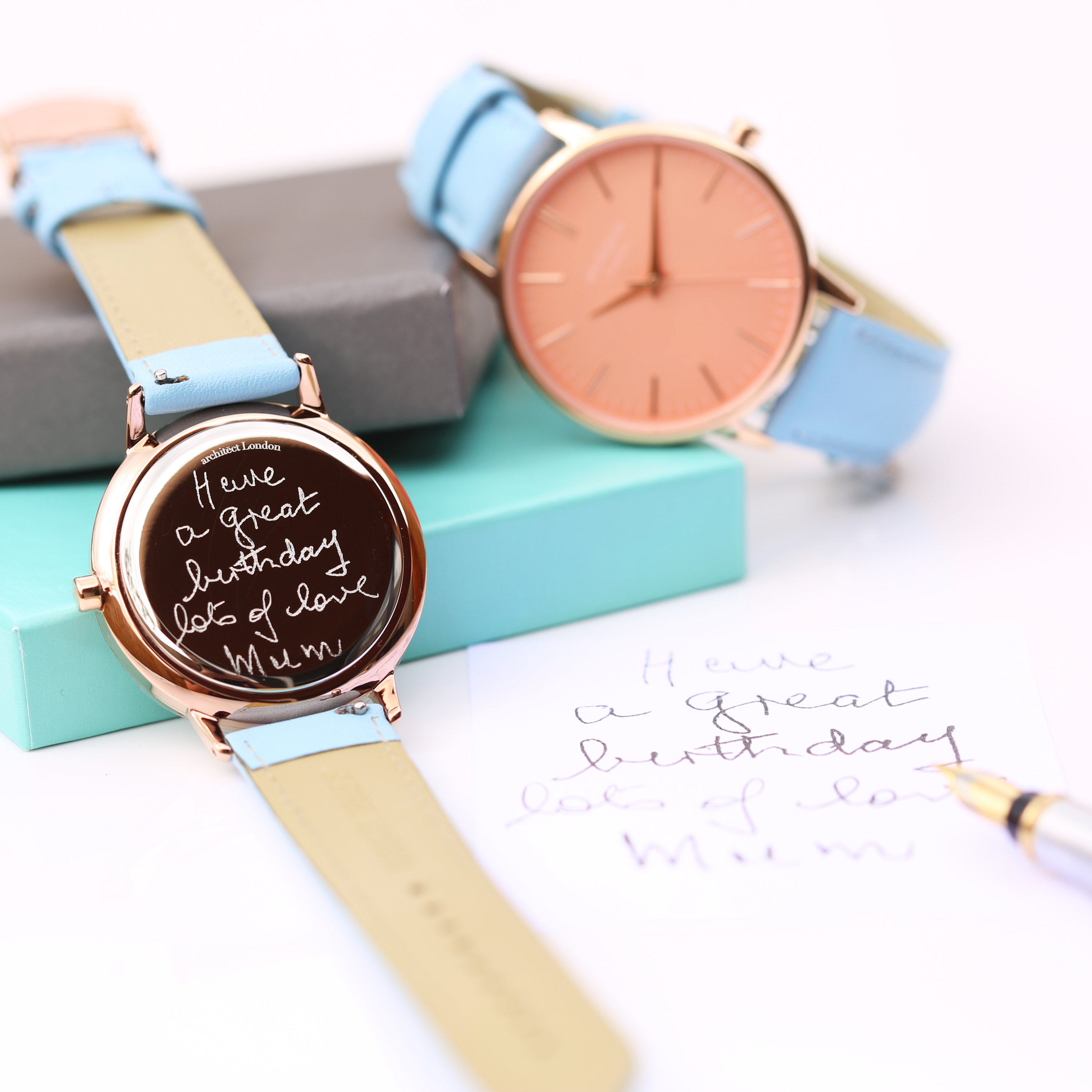 Ladies Architēct Coral watch featuring handwriting engraving and a light blue genuine leather strap, showcasing a stylish apricot coral dial.