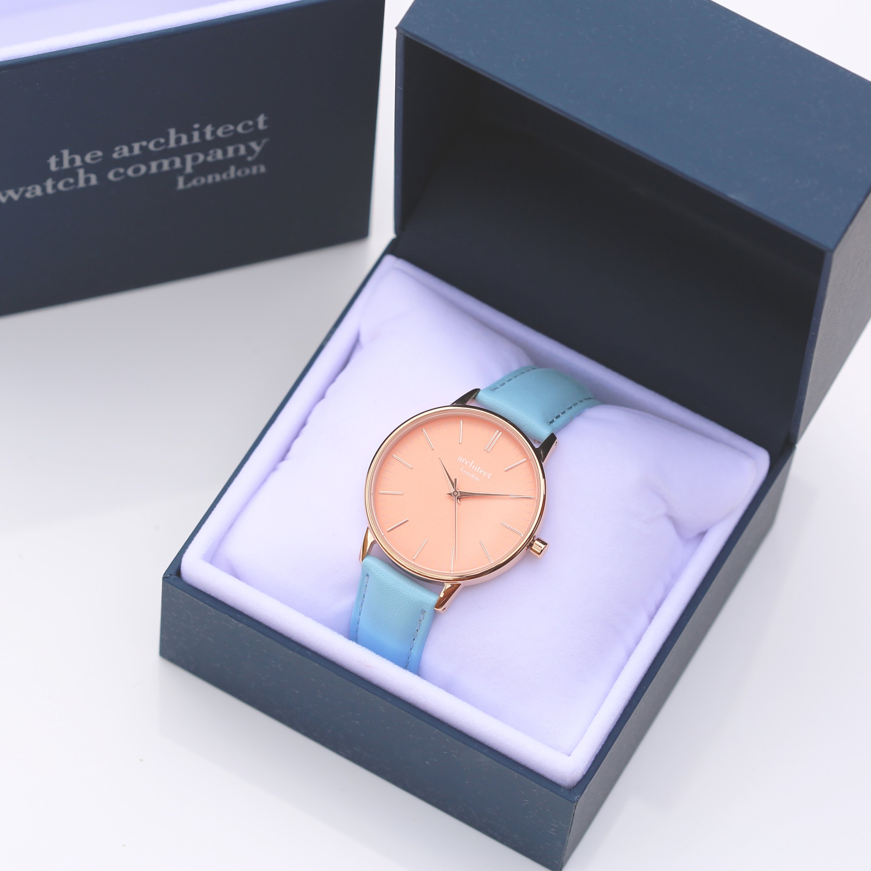 Ladies Architēct Coral watch featuring handwriting engraving and a light blue genuine leather strap, showcasing a stylish apricot coral dial.