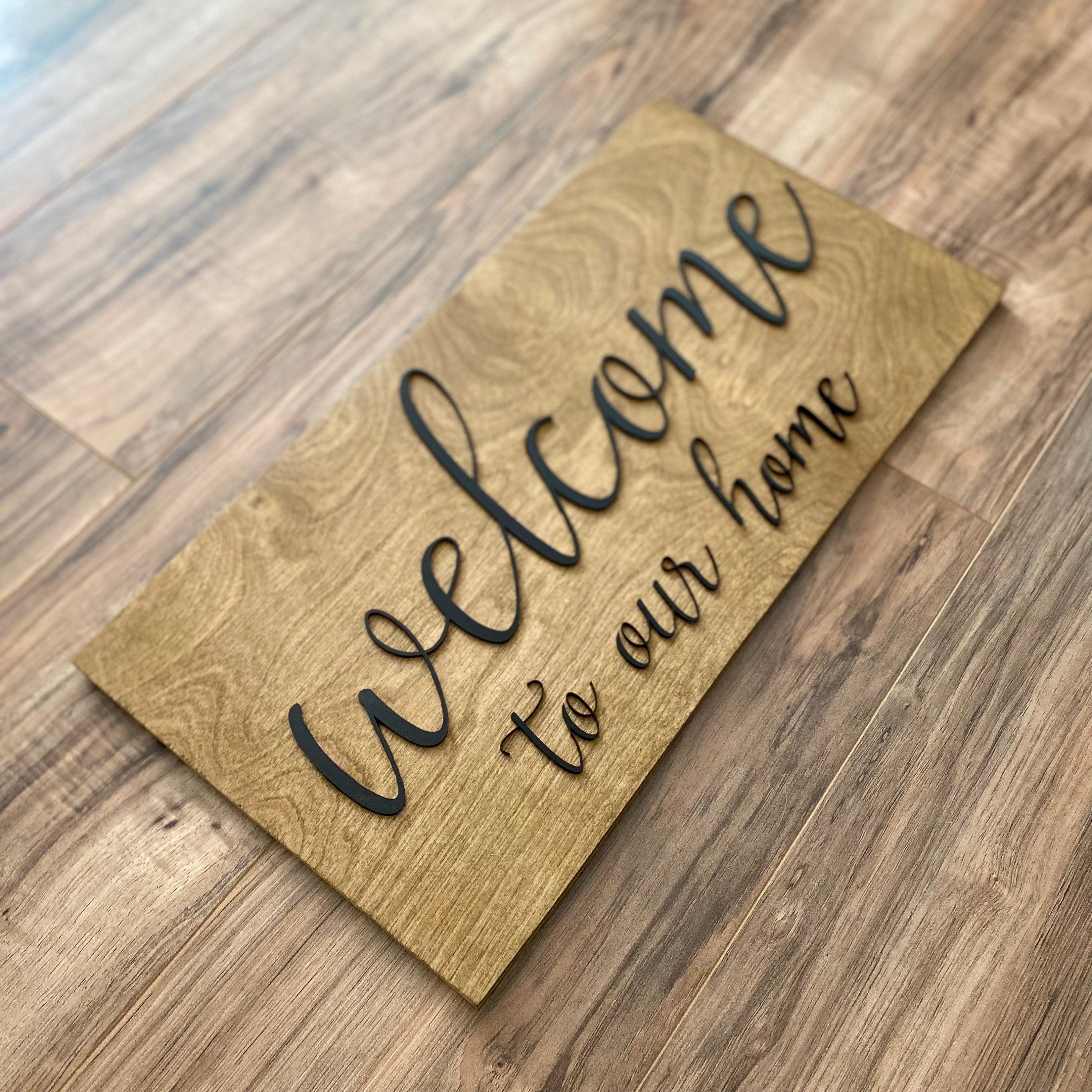 Laser Cut Wooden Welcome Sign made of birch plywood with white and black acrylic lettering, showcasing a stylish design for home decor.