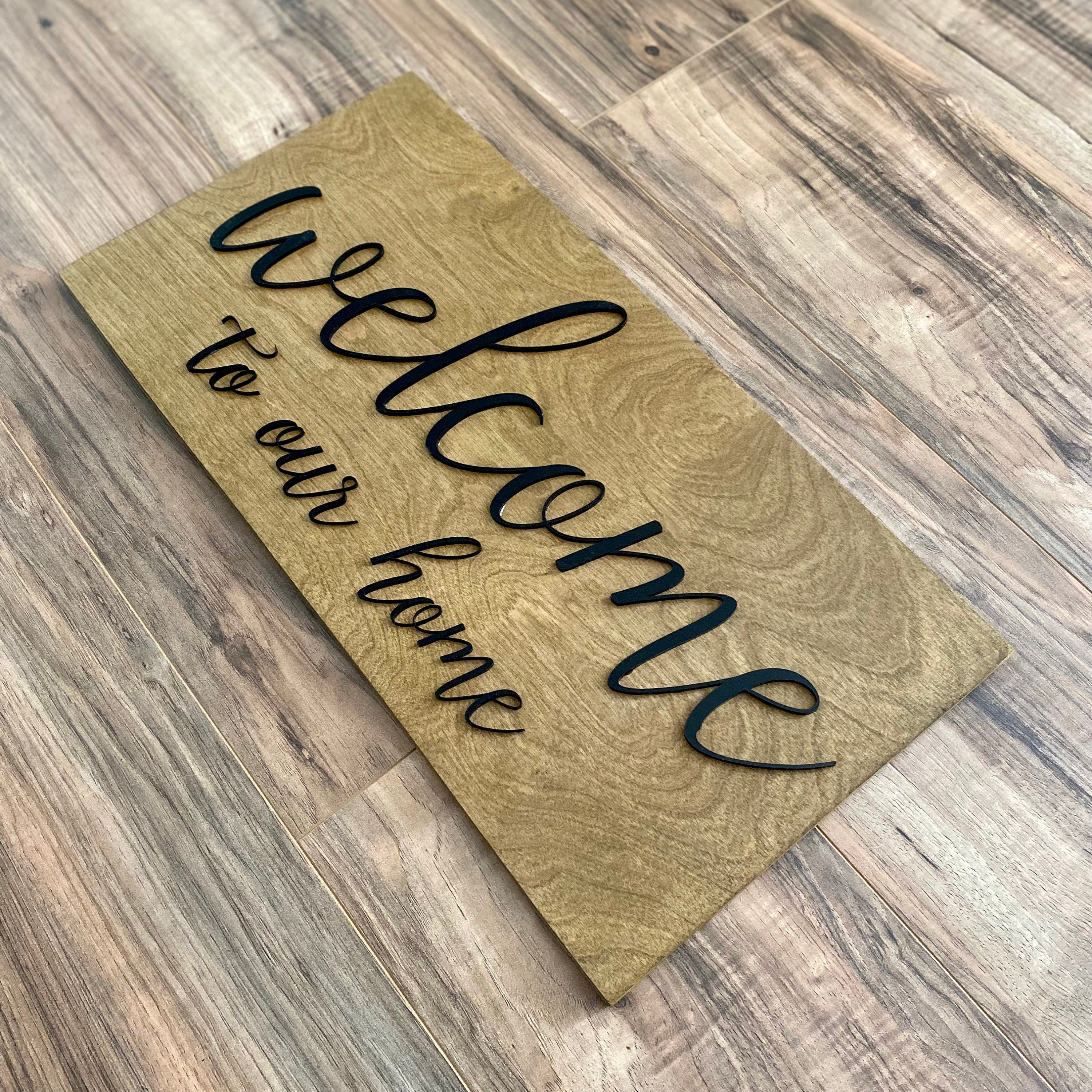 Laser Cut Wooden Welcome Sign made of birch plywood with white and black acrylic lettering, showcasing a stylish design for home decor.