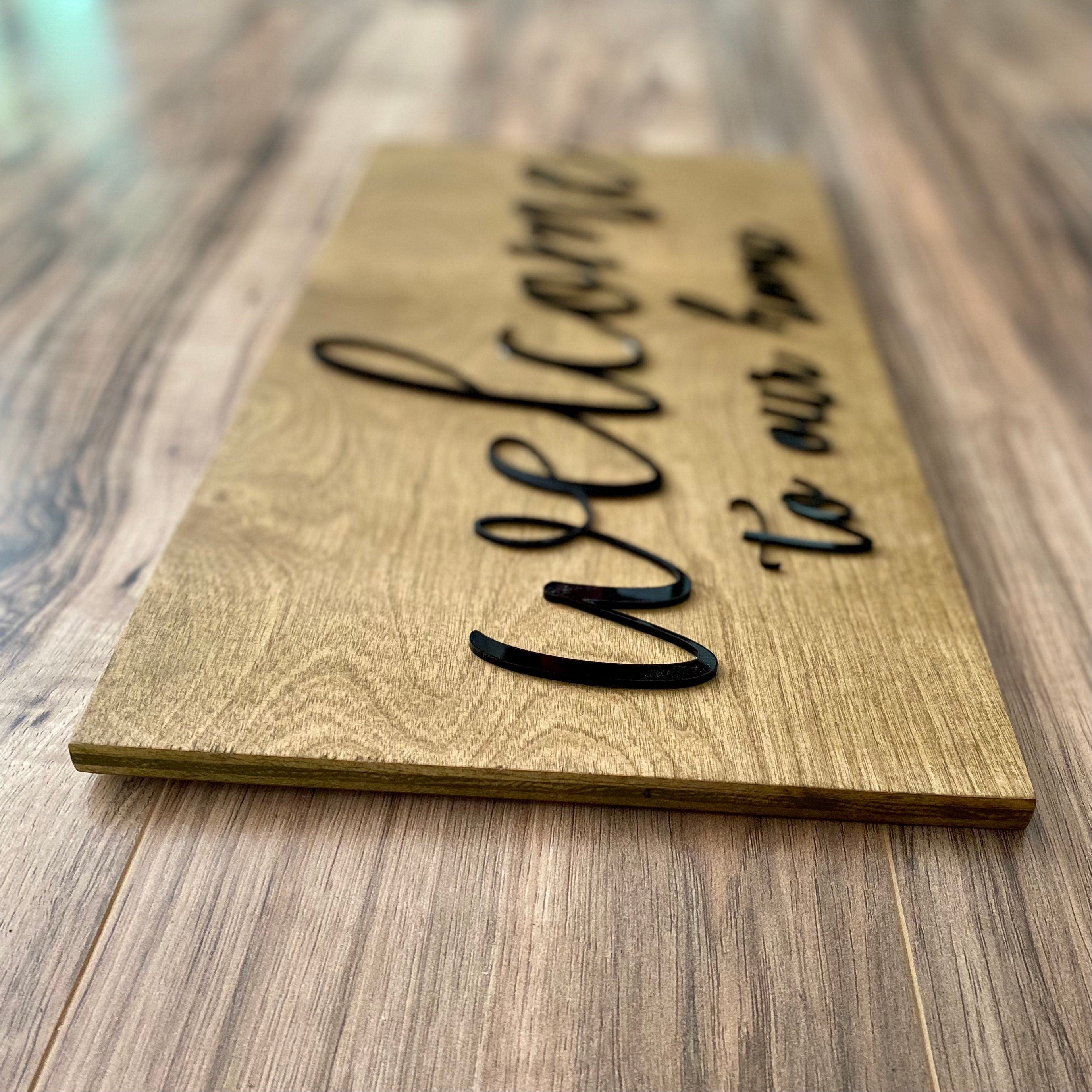 Laser Cut Wooden Welcome Sign made of birch plywood with white and black acrylic lettering, showcasing a stylish design for home decor.