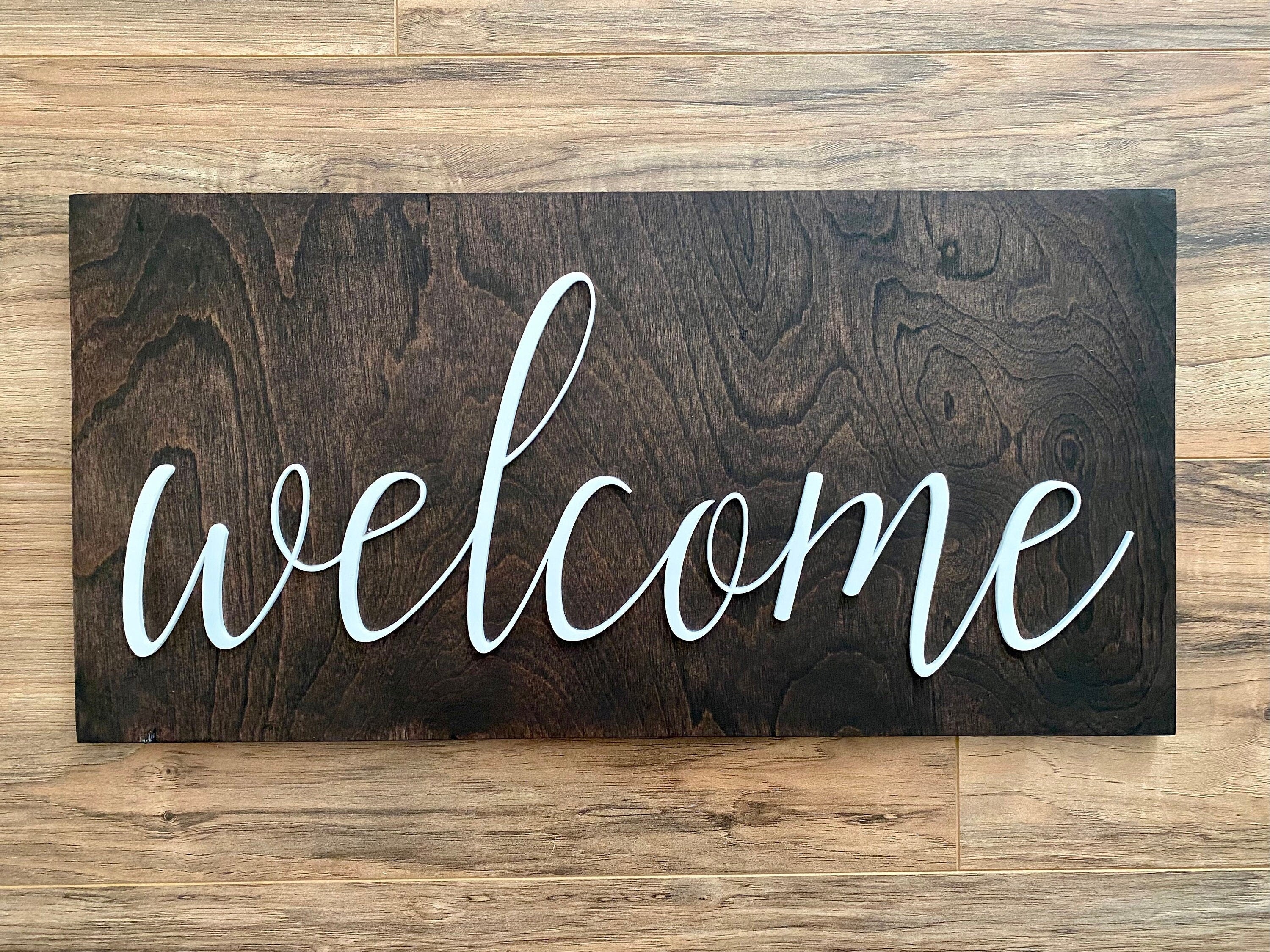 Laser Cut Wooden Welcome Sign made of birch plywood with white and black acrylic lettering, showcasing a stylish design for home decor.