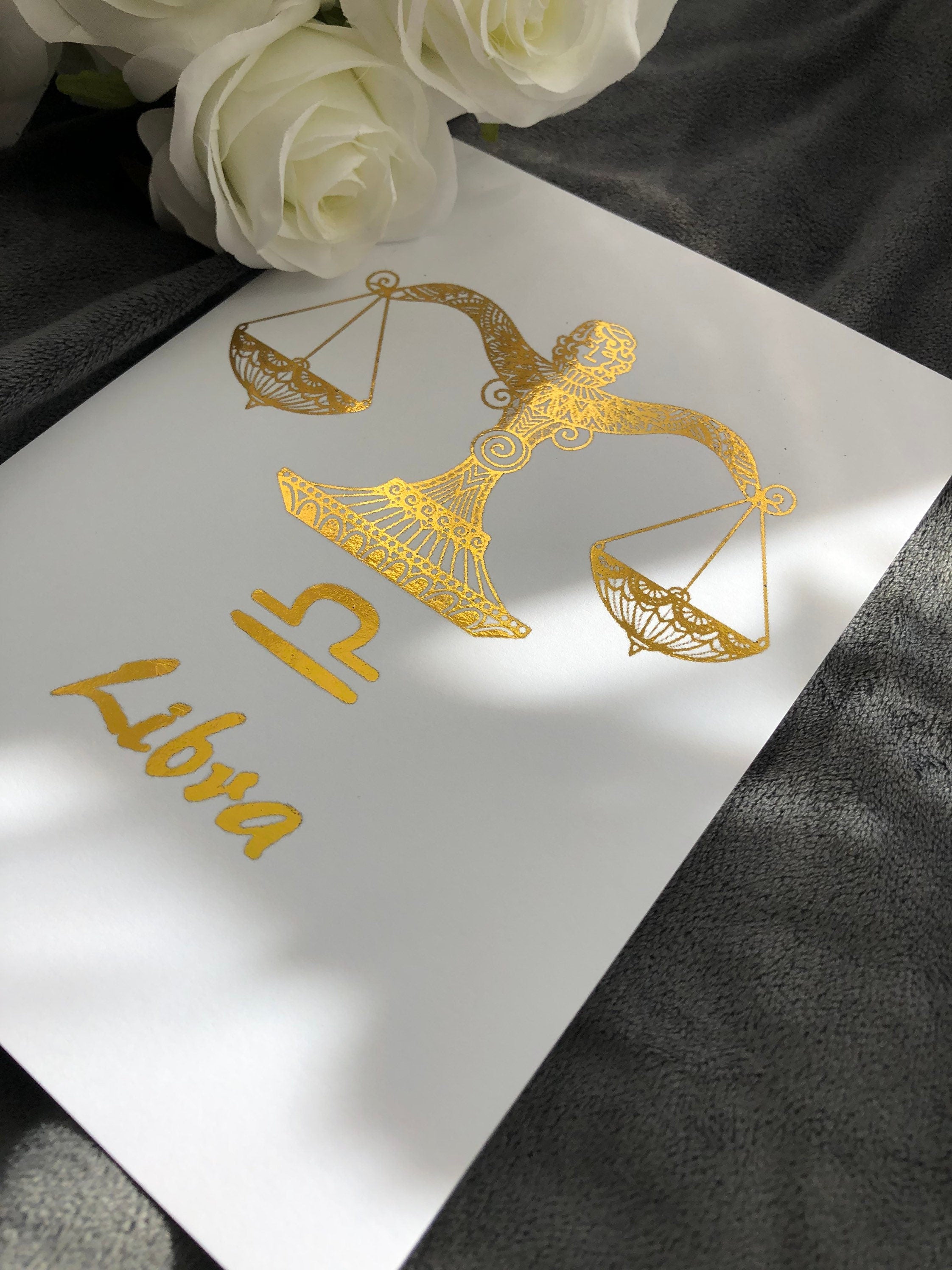 A beautiful Libra Star Sign Foil Print featuring elegant scales design, symbolizing balance and harmony, perfect for home decor.