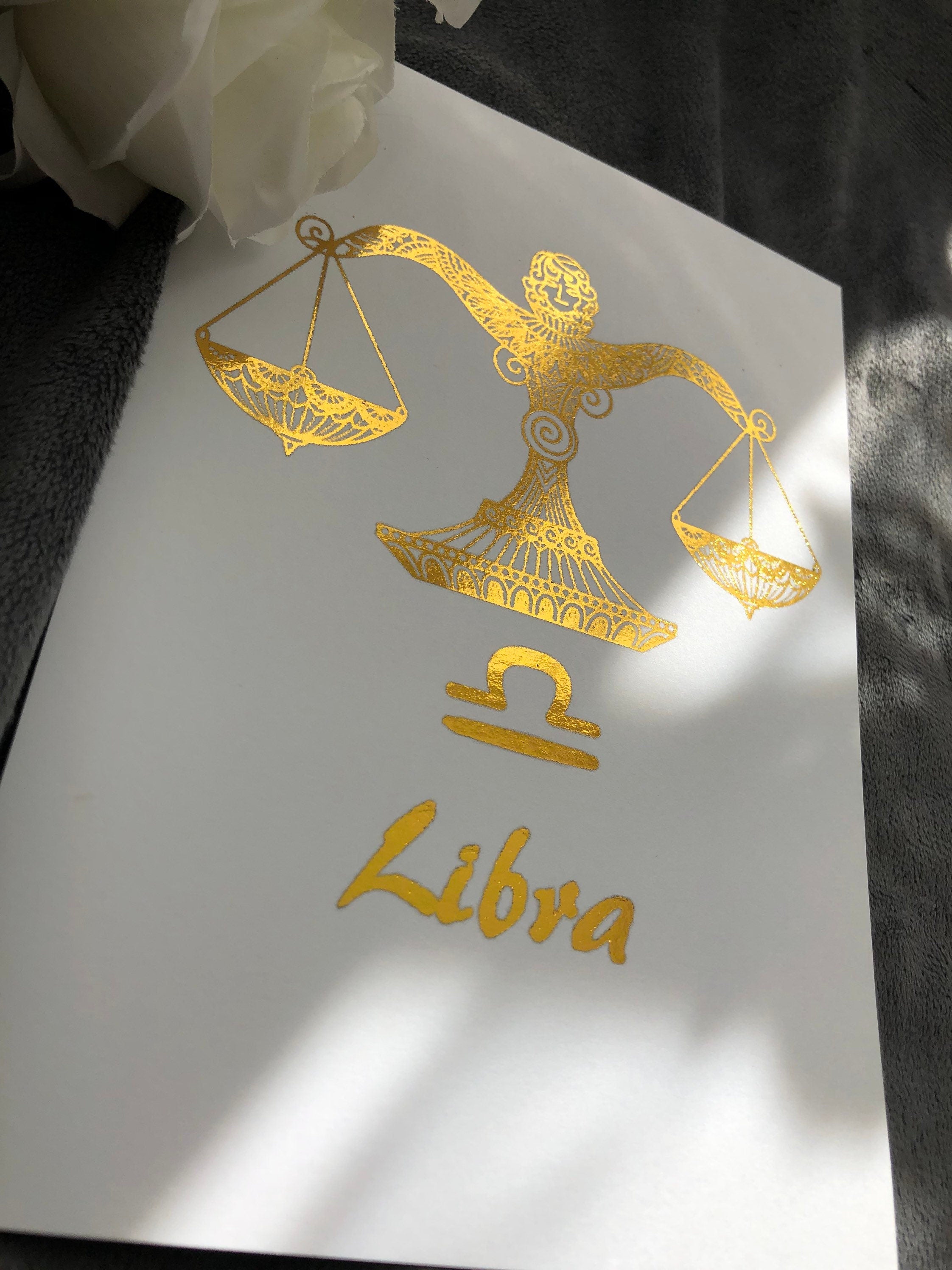 A beautiful Libra Star Sign Foil Print featuring elegant scales design, symbolizing balance and harmony, perfect for home decor.