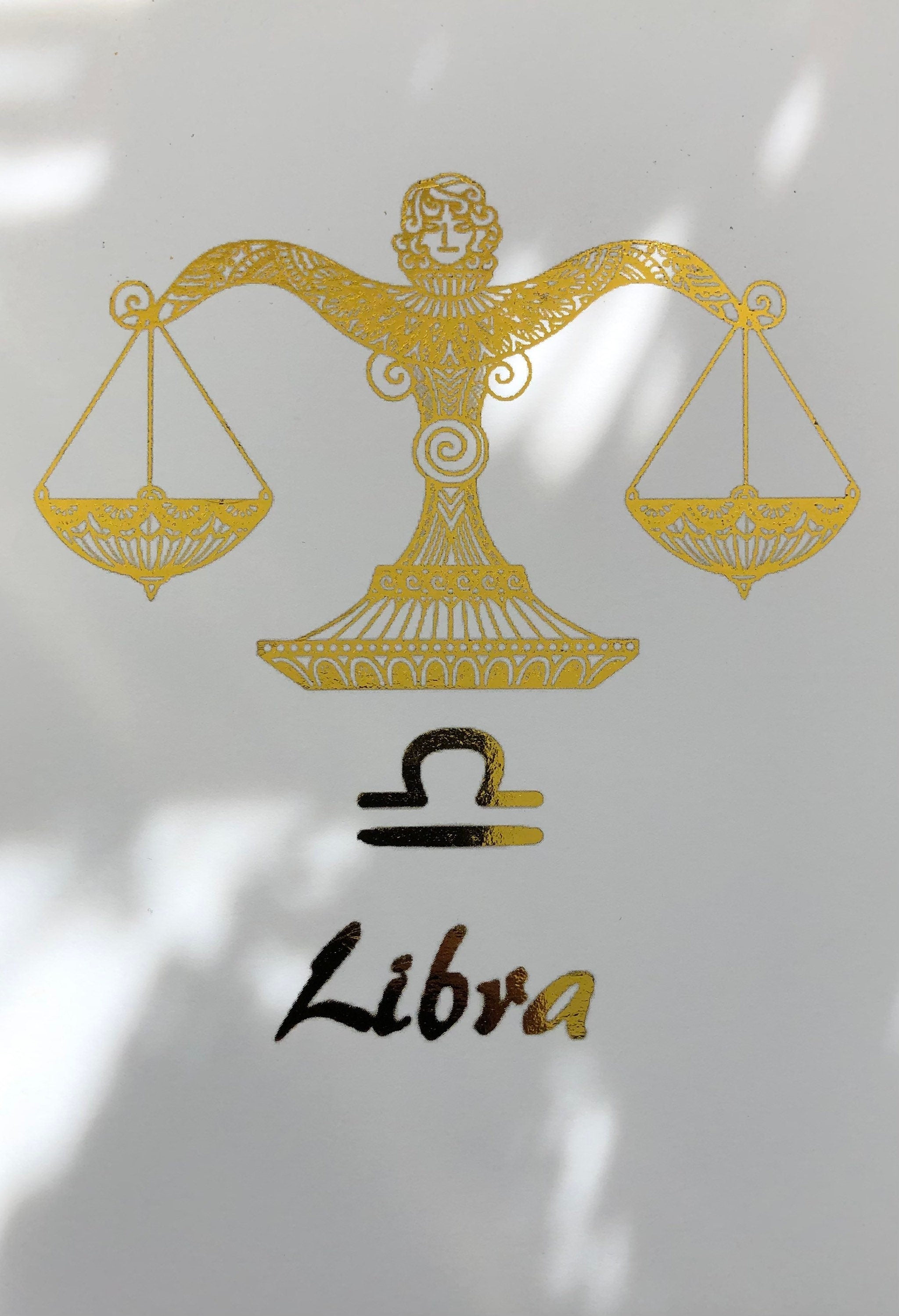 A beautiful Libra Star Sign Foil Print featuring elegant scales design, symbolizing balance and harmony, perfect for home decor.