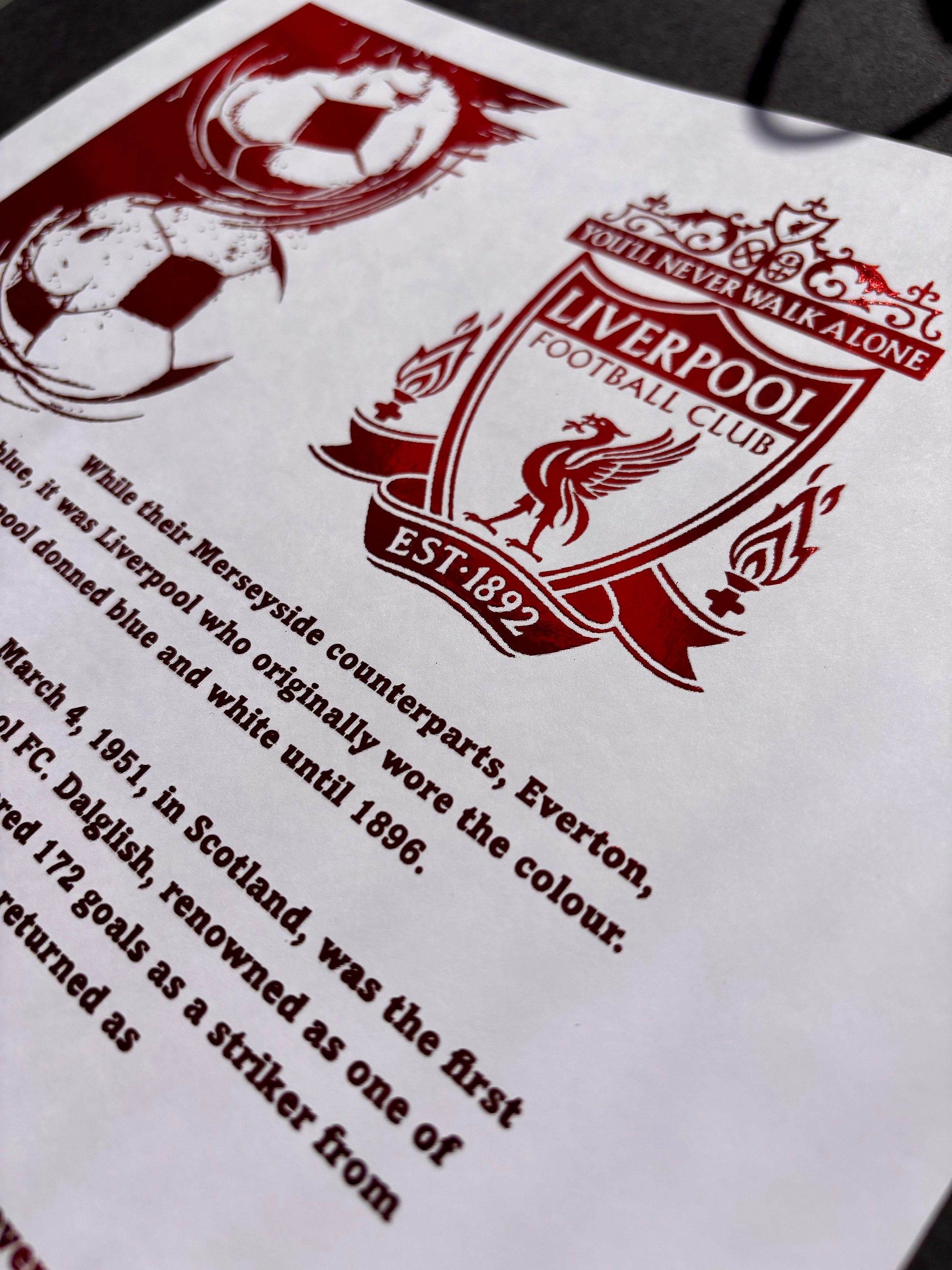 A stunning A4 foil print featuring the Liverpool FC logo in vibrant red foil, showcasing the club's rich history.