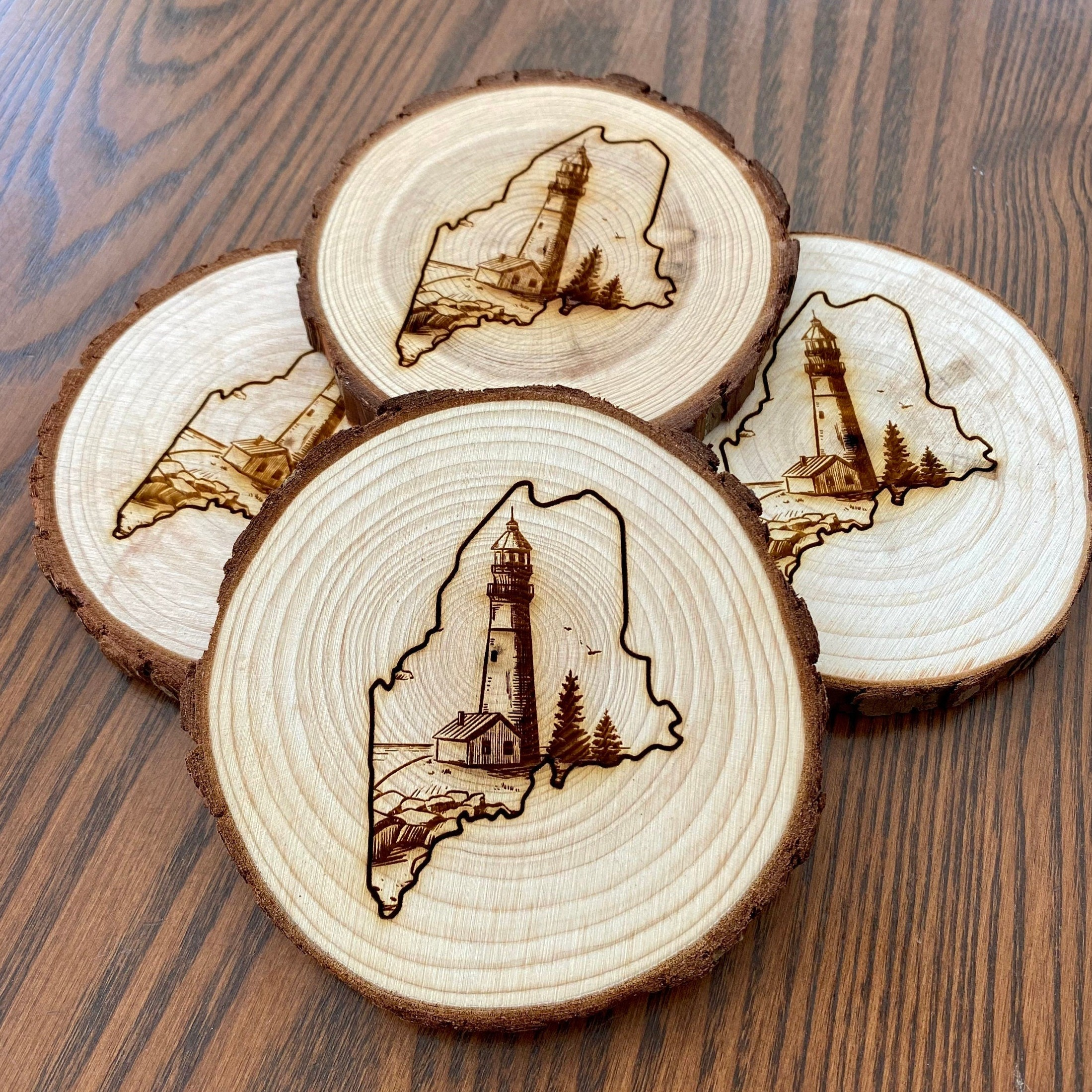 Maine Lighthouse Engraved Wood Coaster Set featuring state outline and coastal scene.