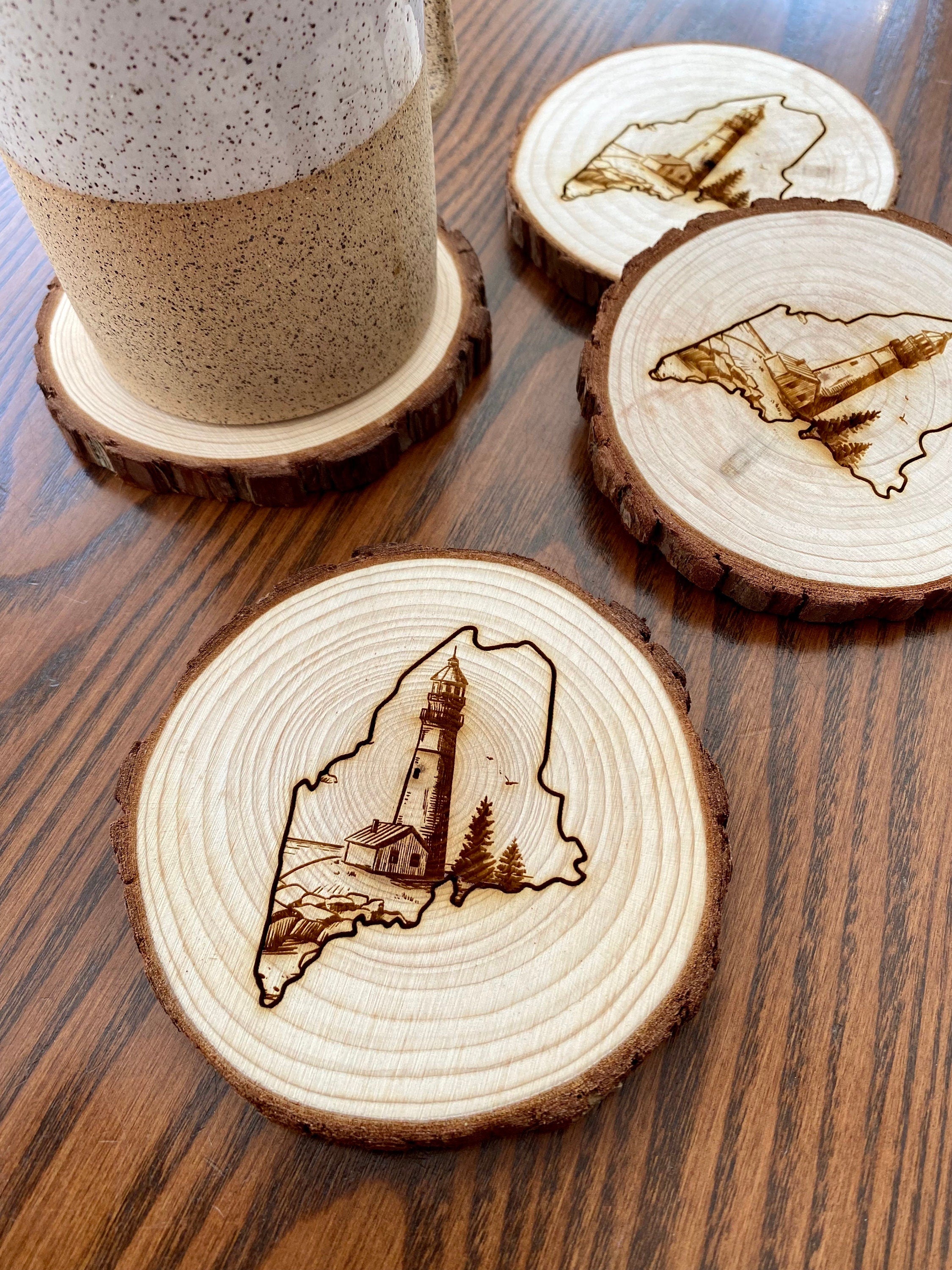 Maine Lighthouse Engraved Wood Coaster Set featuring state outline and coastal scene.