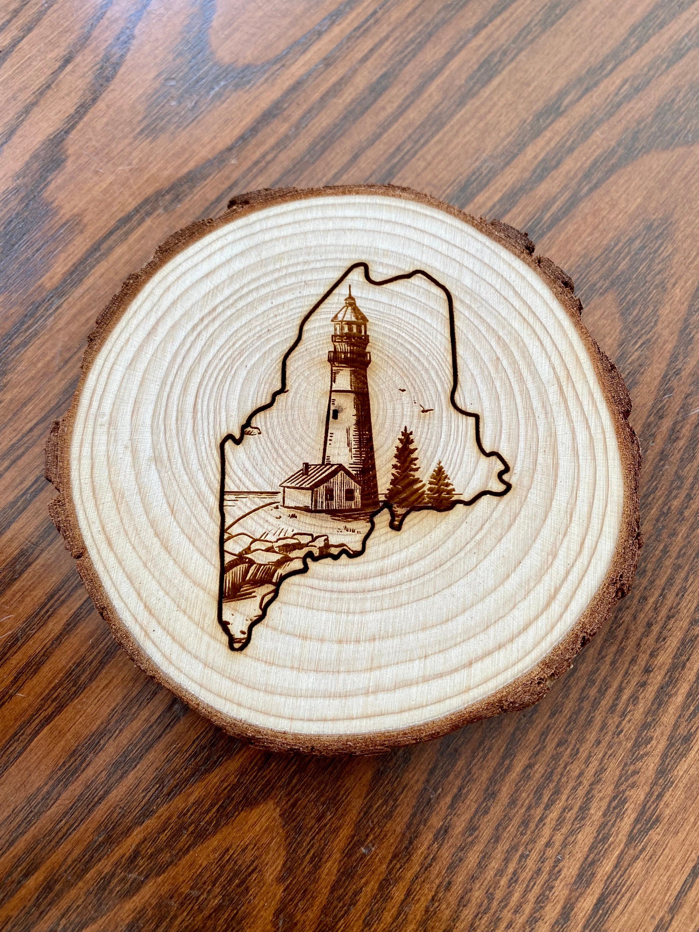 Maine Lighthouse Engraved Wood Coaster Set featuring state outline and coastal scene.